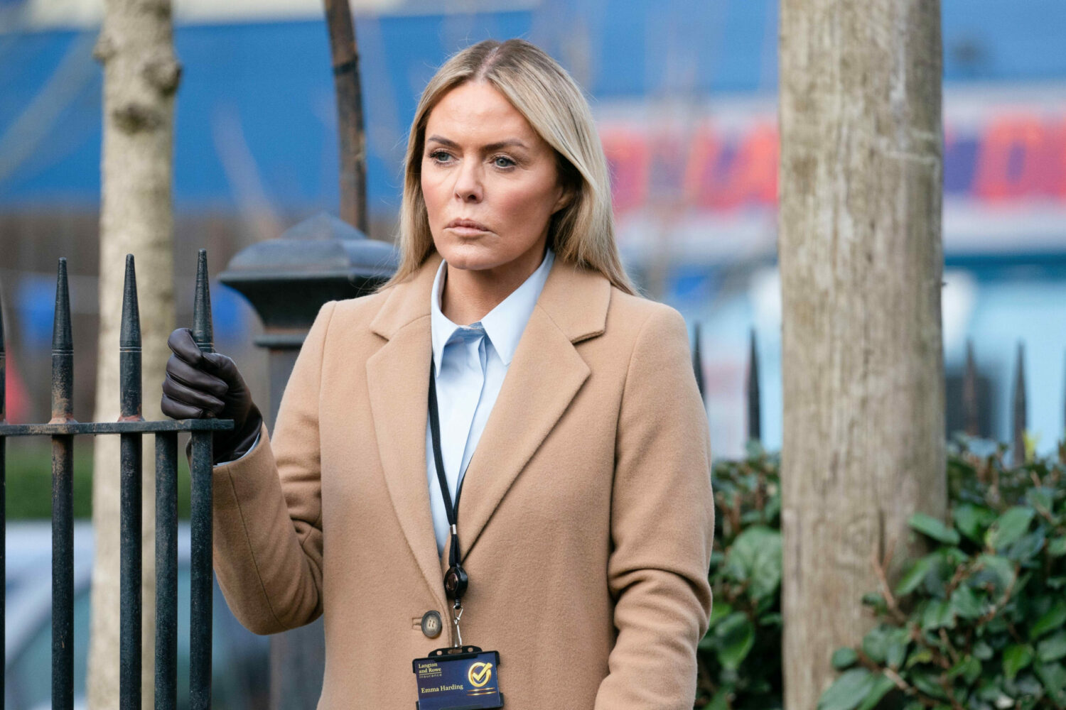 Emma standing next to a gate in EastEnders