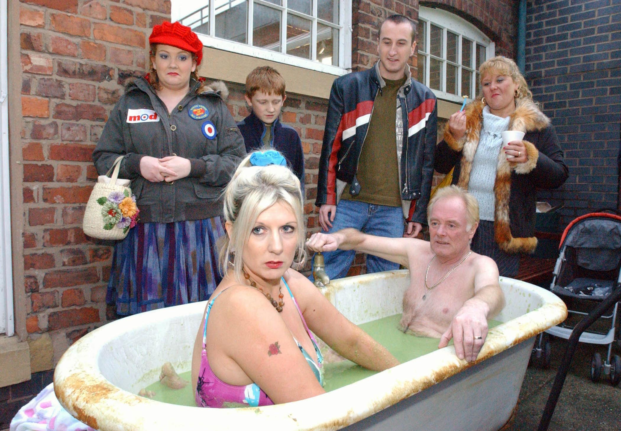 Les and Yana sit in a bath of peas to raise money for Cilla's cancer fund 