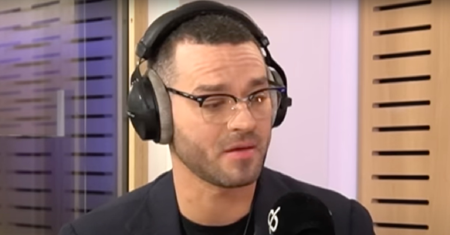 Matt Willis wearing headphones on Gi Fletcher's podcast