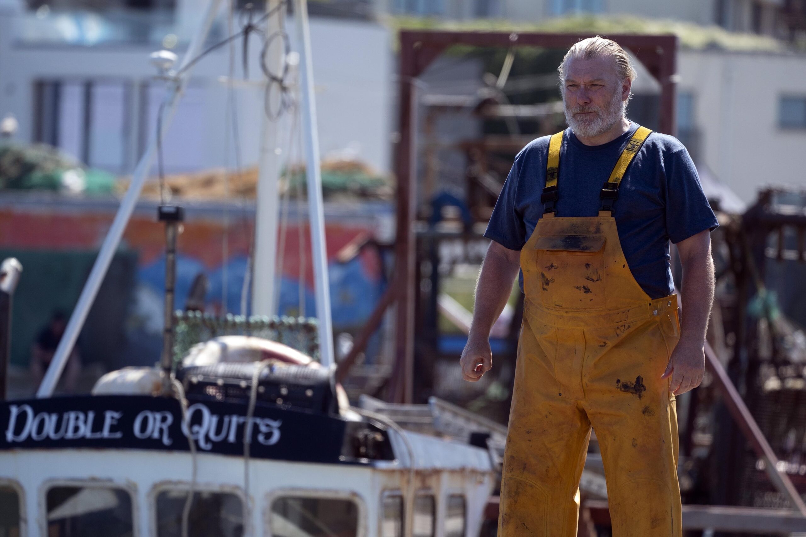 Bob wearing fishing overalls at the harbour in The Catch