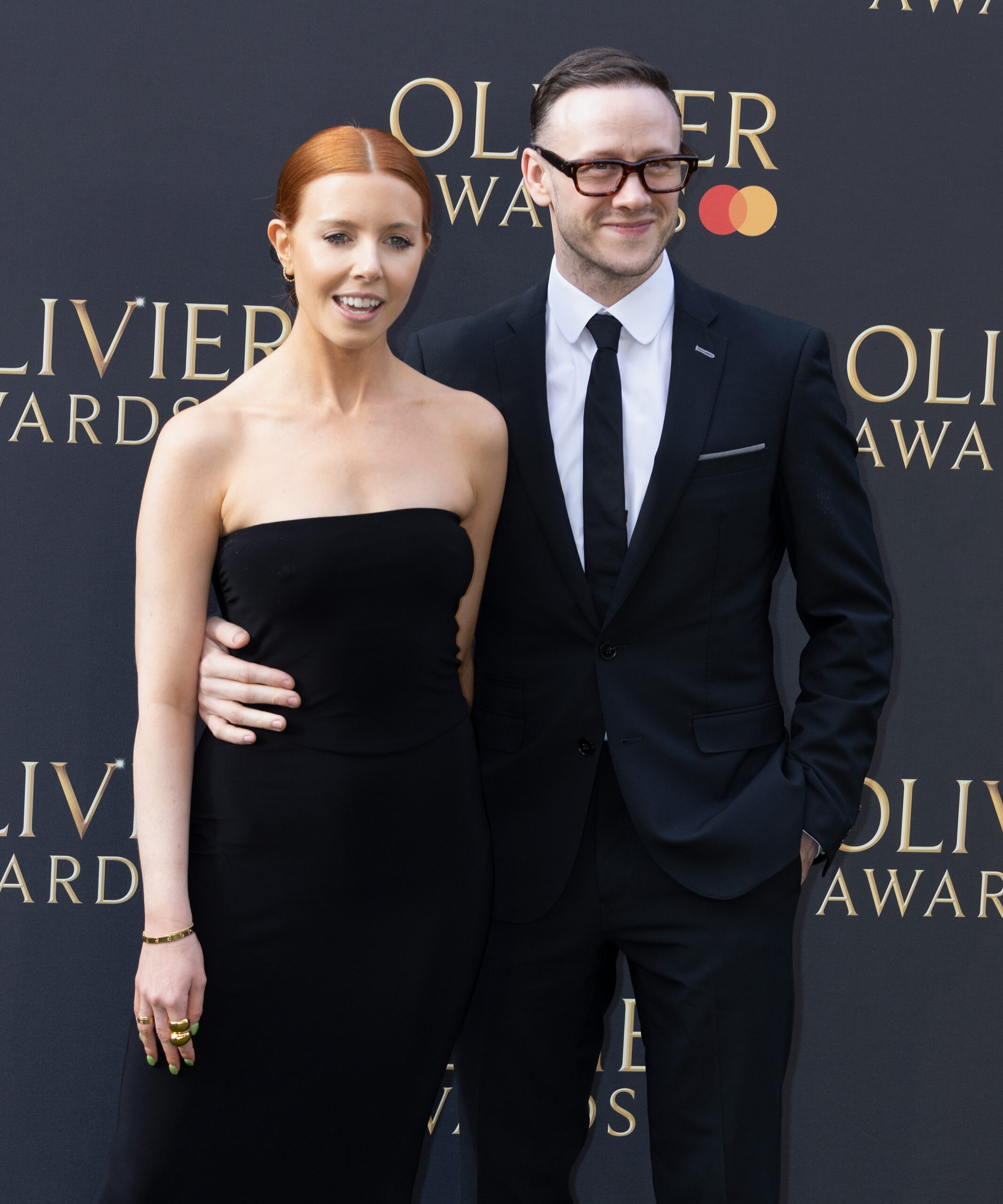 Kevin Clifton wrapping his arm around Stacey Dooley