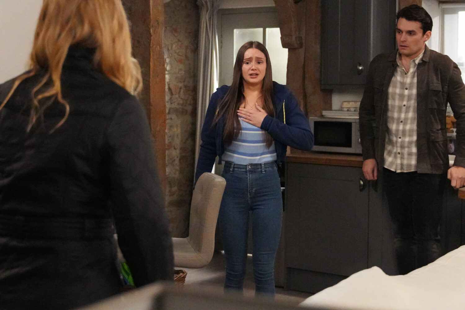 Frantic Sarah Sugden clutches her chest unable to breathe as Charity Dingle and Mackenzie Boyd look on