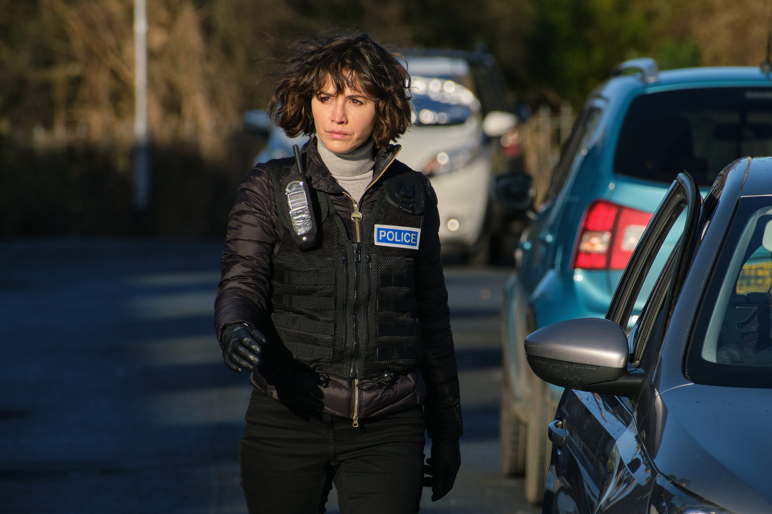 Ann Gallagher walks down a street in her police uniform