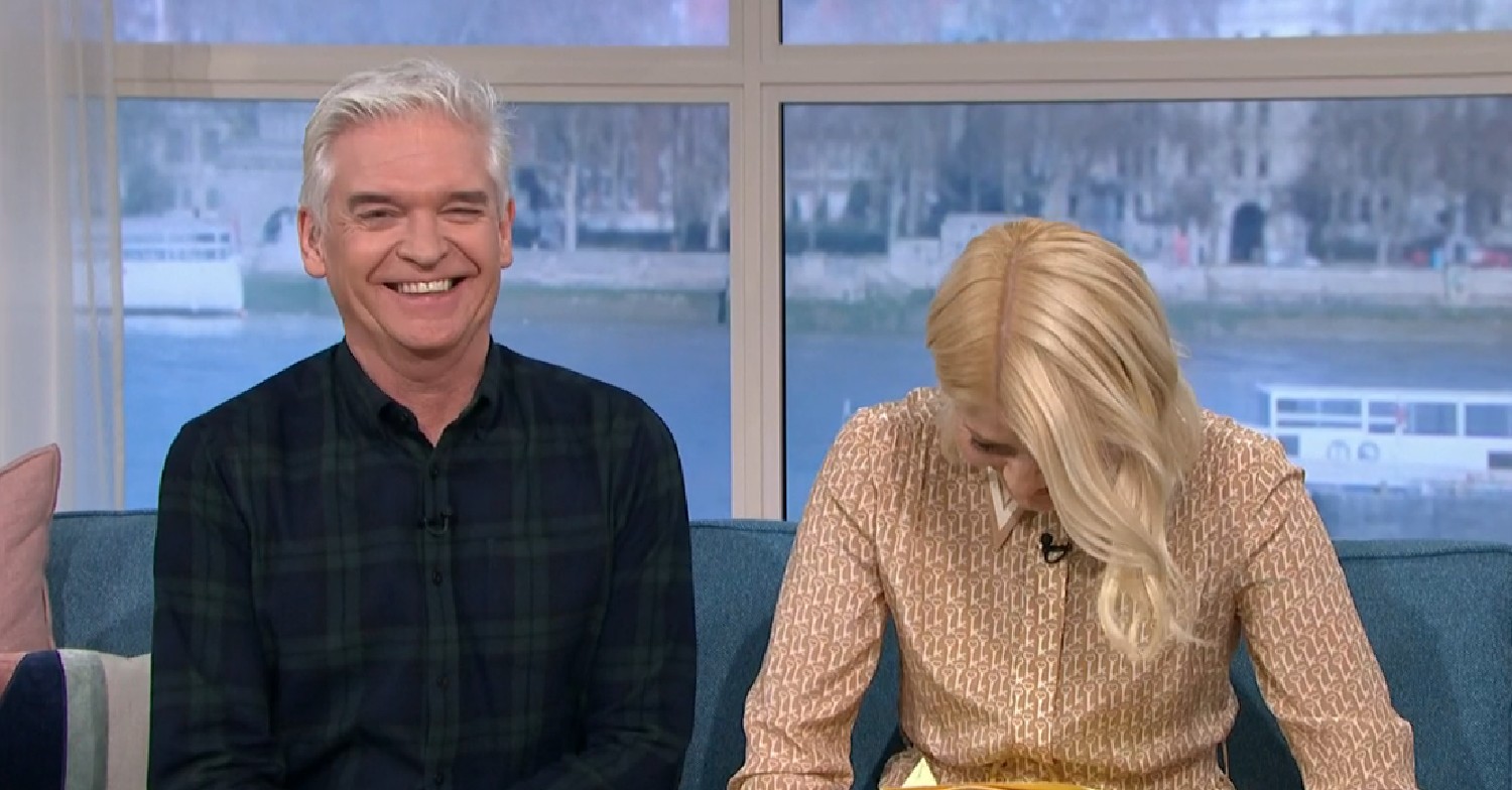 Phillip laughing as Holly looks down giggling on This Morning