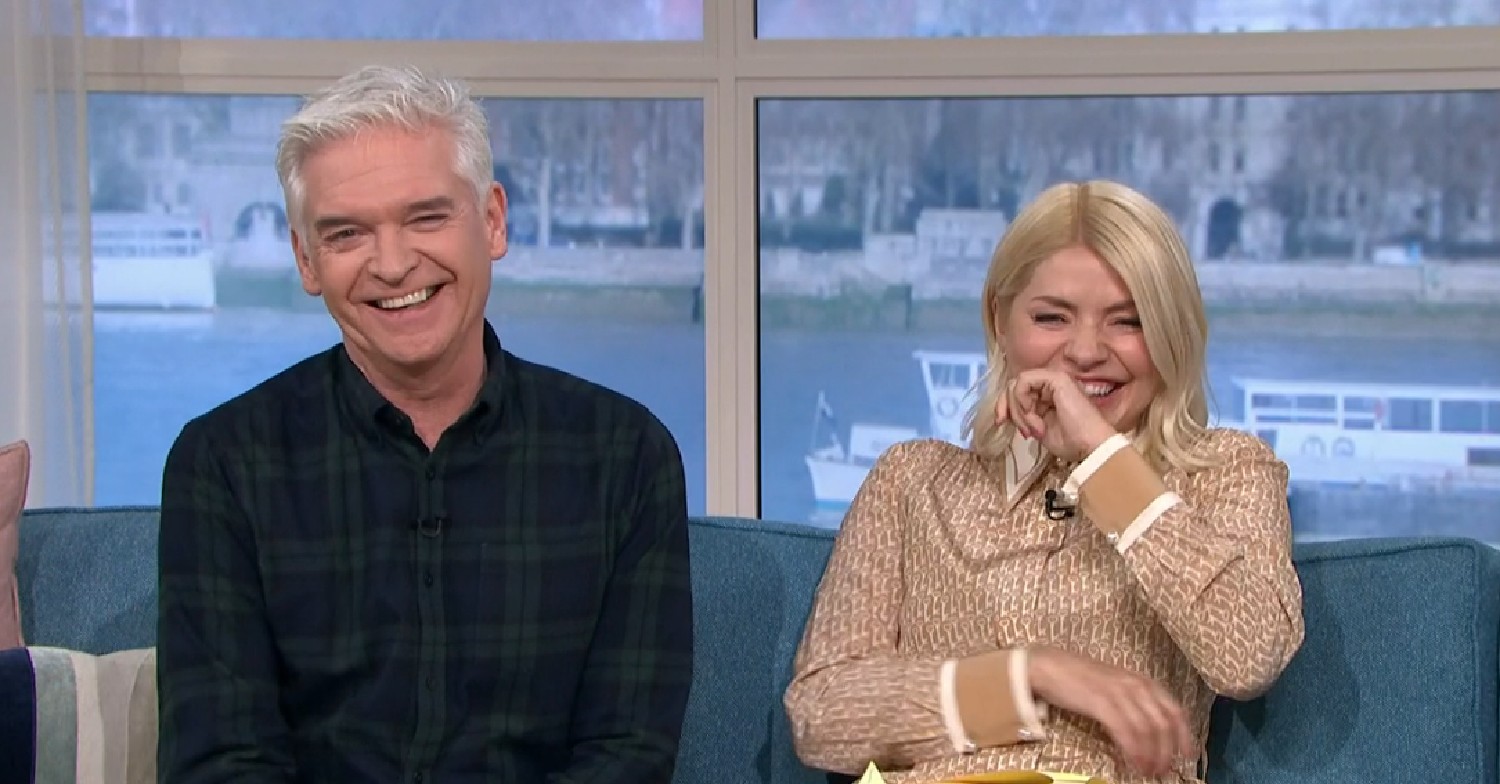 Phillip and Holly laughing on blue sofa