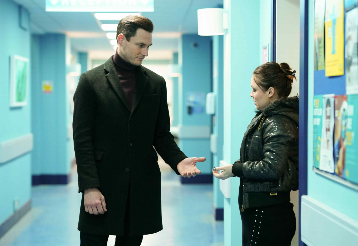 Zack and Whitney talk in the hospital corridor on EastEnders