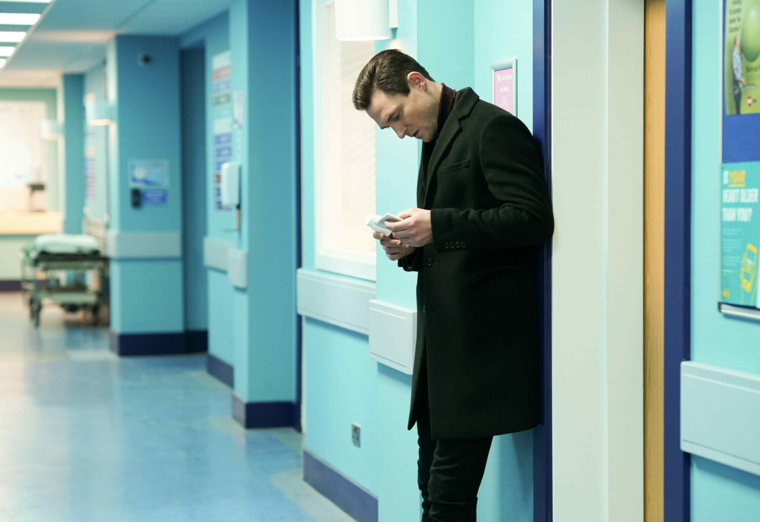 Zack, in the hospital, reading medication box on EastEnders