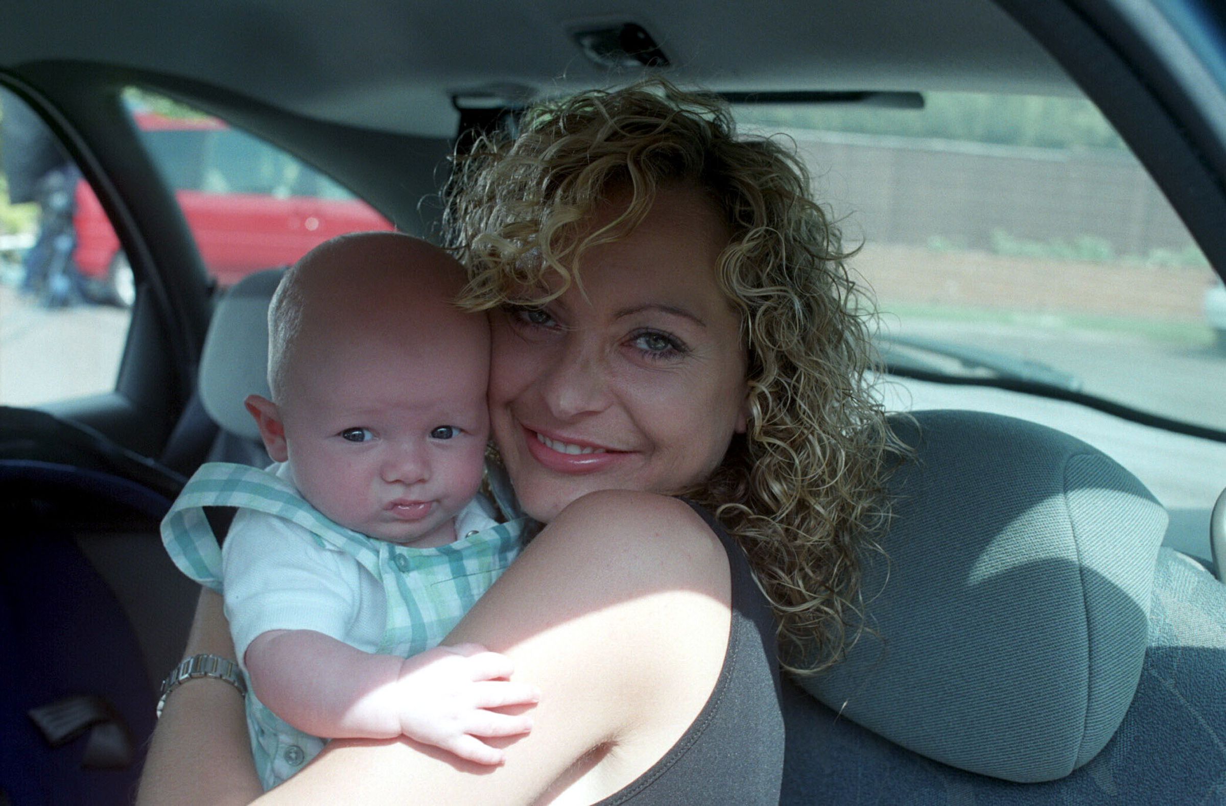 Maxine Peacock cuddles baby Joshua