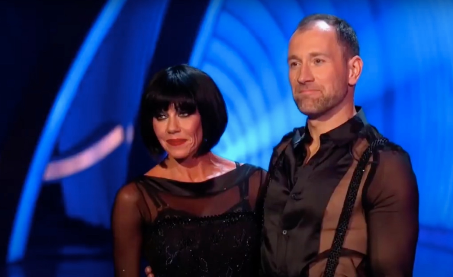 Michelle Heaton and Łukasz Rozycki wearing black in Dancing On Ice