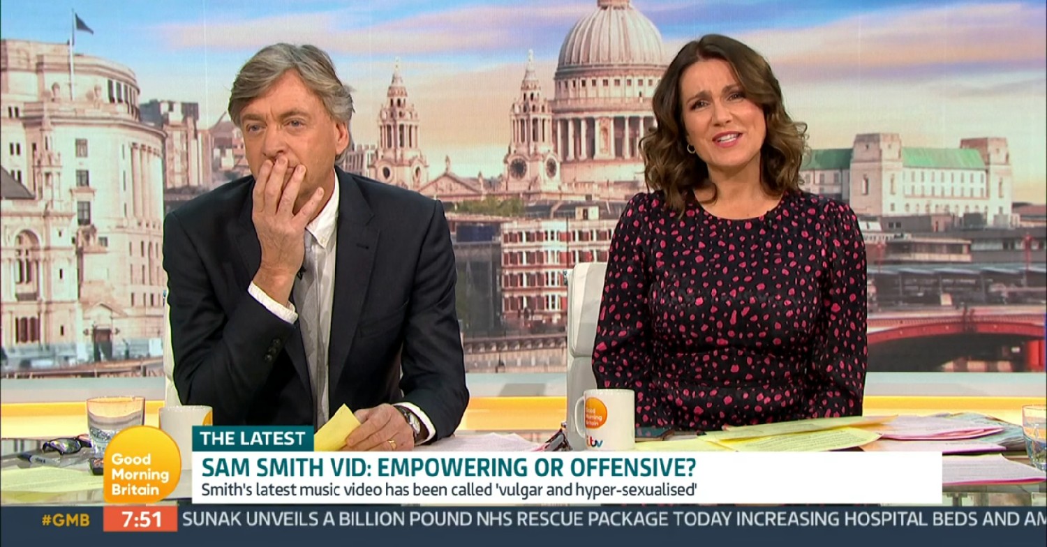 Richard Madeley with his hand on his mouth as Susanna Reid smiles on GMB today 