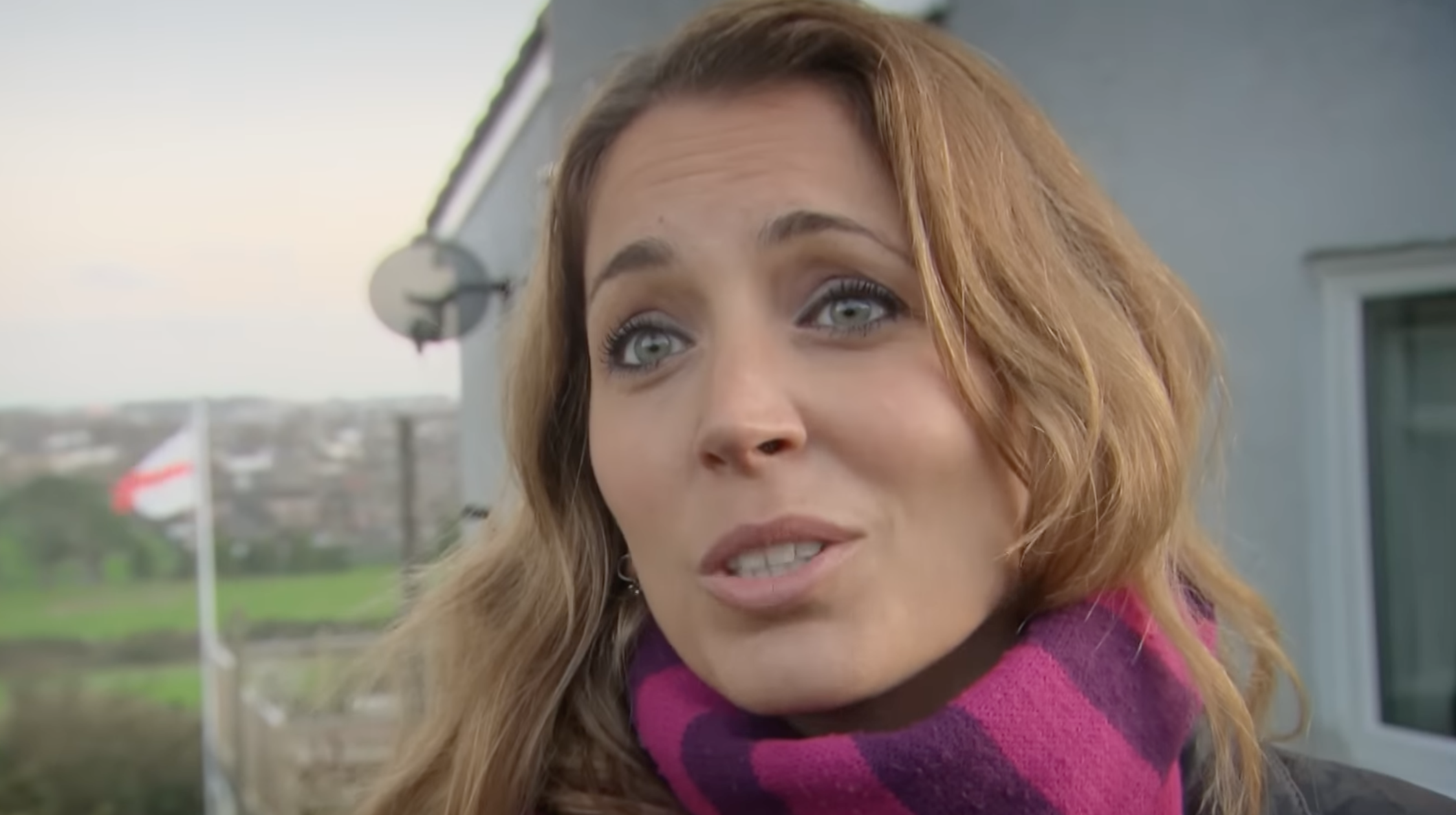 Jasmine Harman wearing a scarf presenting