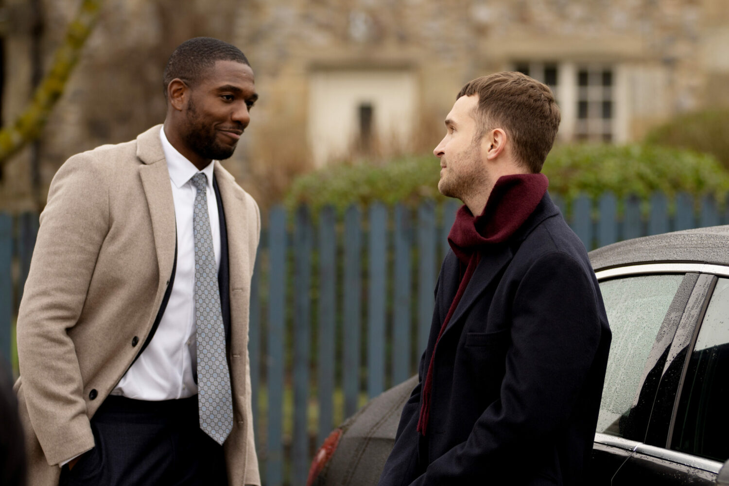 Ethan in Emmerdale smiles at a mystery man by his car