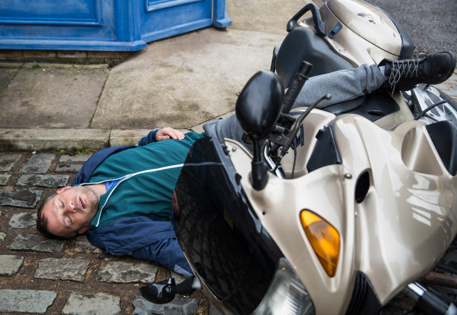 Paul lying unconscious after being hit by Carla's van on Coronation Street