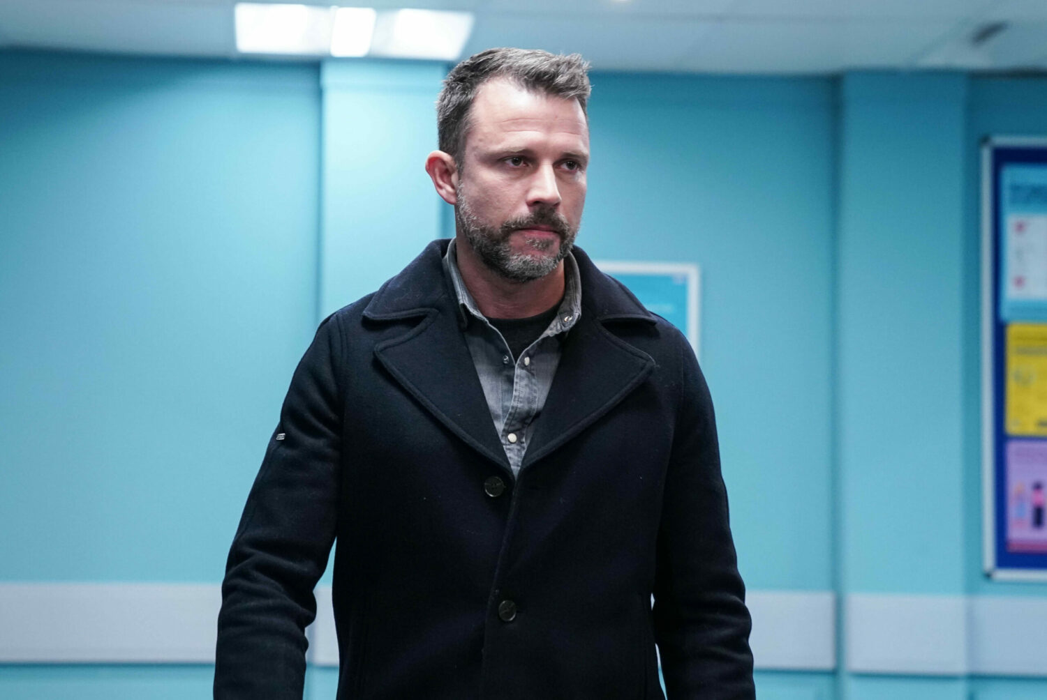 Ryan walks through a hospital corridor on EastEnders 