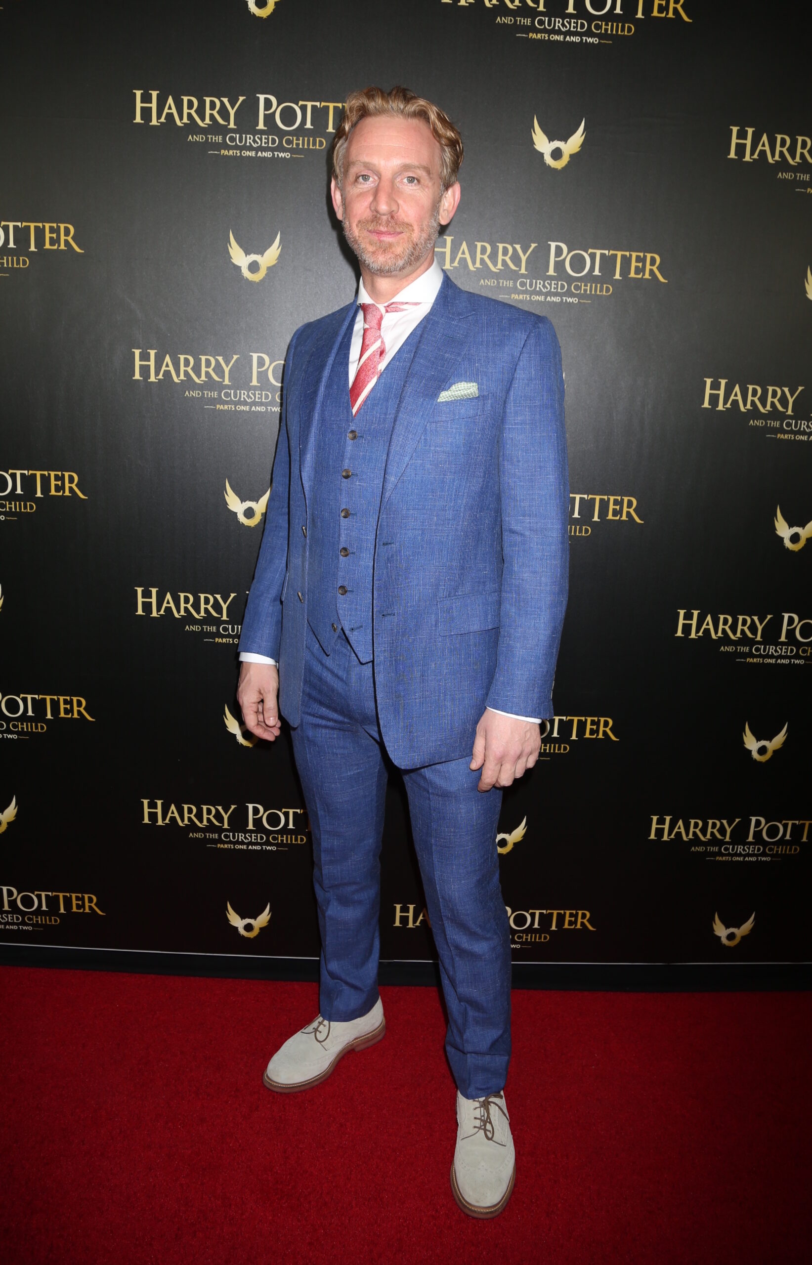 Paul Thornley in blue suit at red carpet event