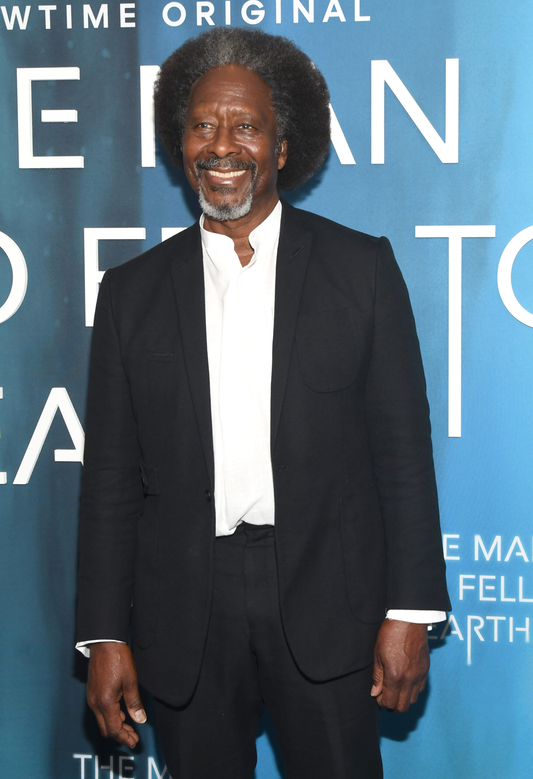 Clarke Peters smiles in a suit at red carpet event