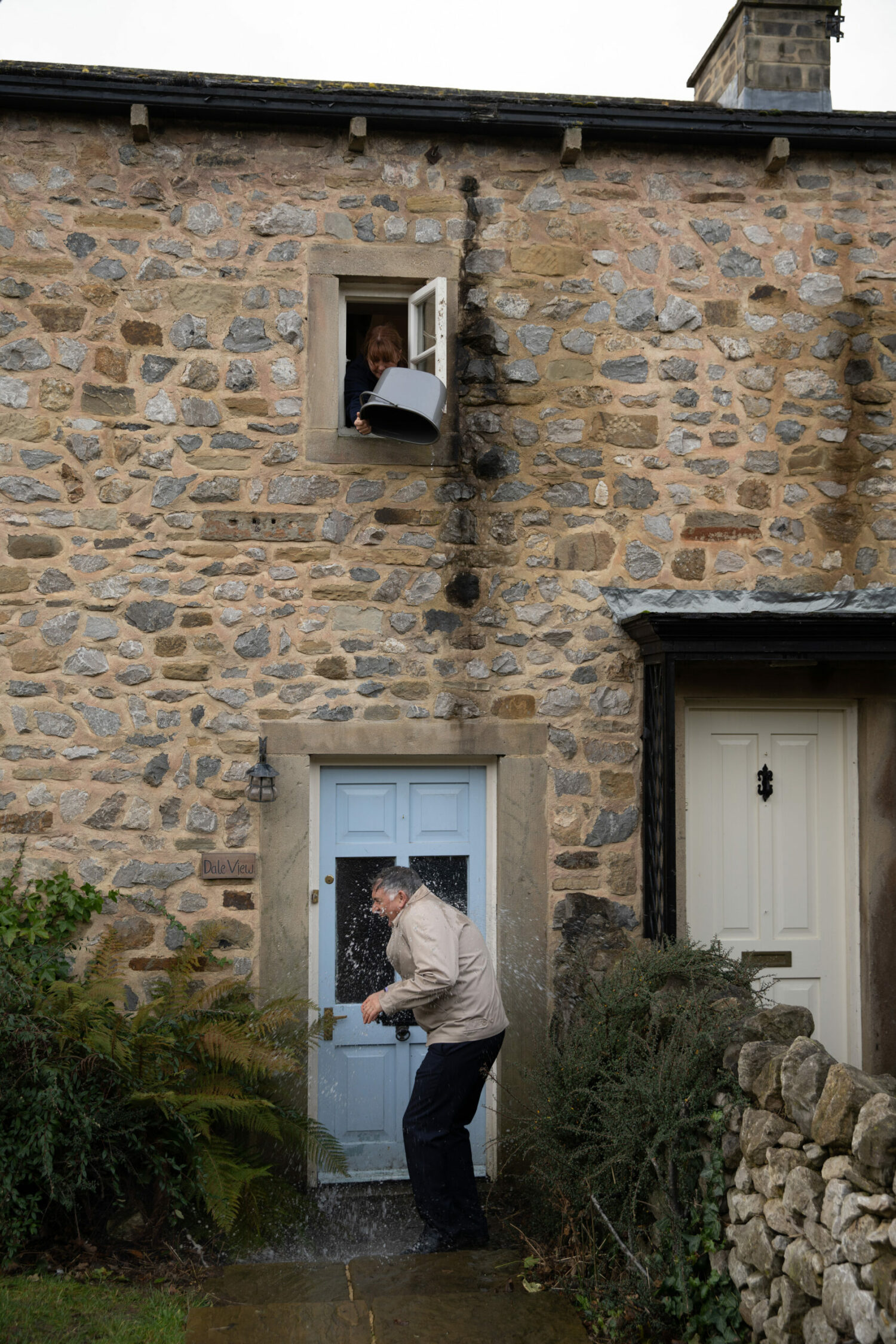 Wendy pours water over Bob from an upstairs window on Emmerdale
