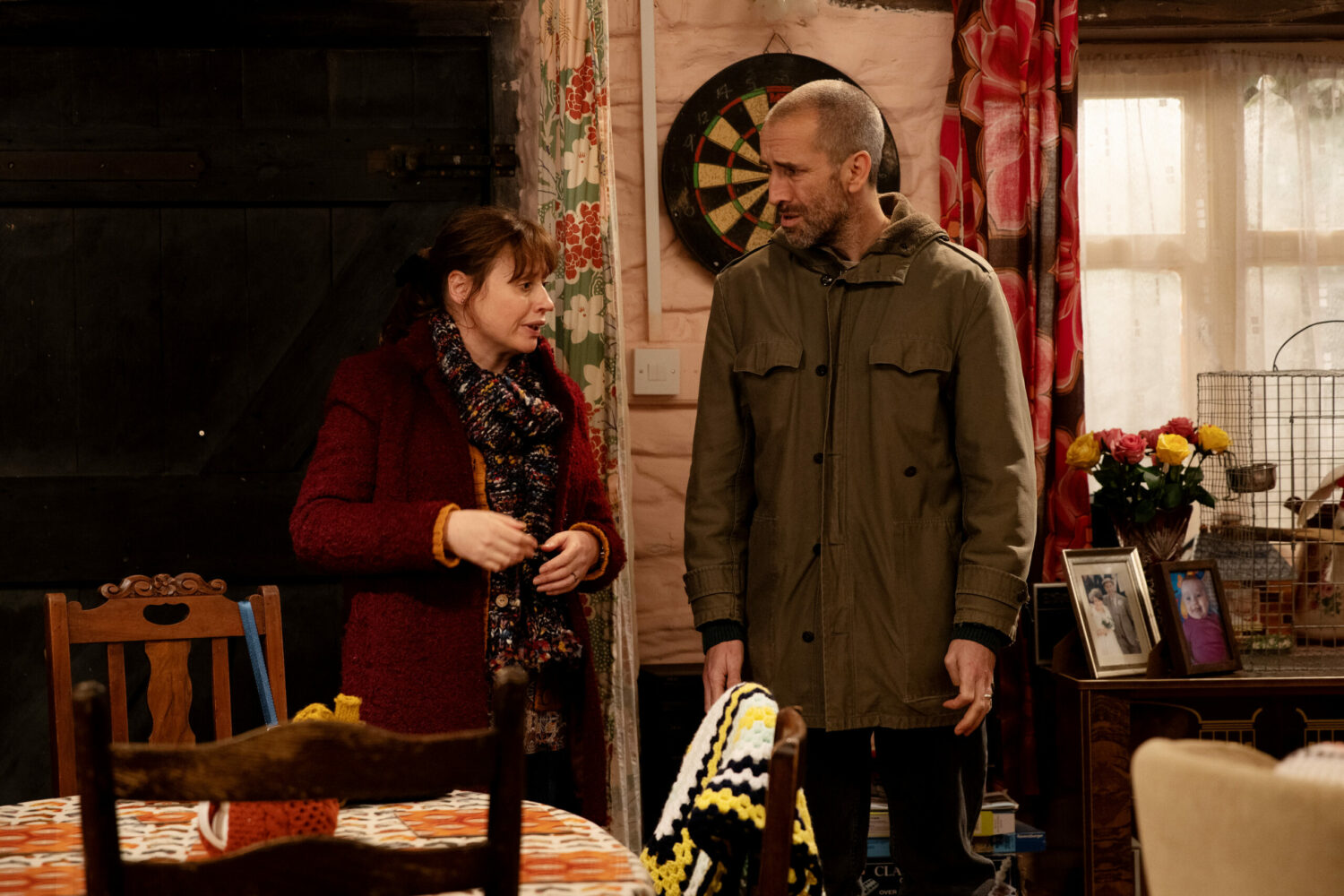 Sam and Lydia talking, looking worried on Emmerdale