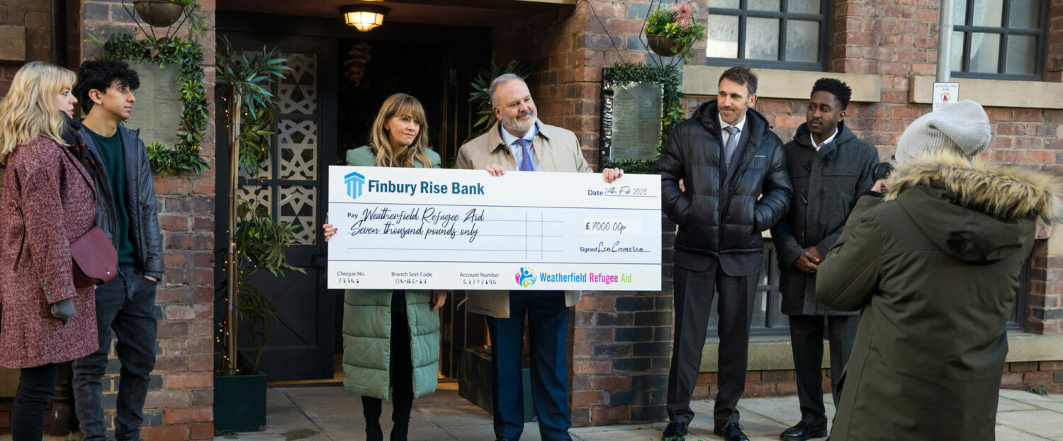 Maria and Len Cameron are photographed holding a large cheque in Coronation Street