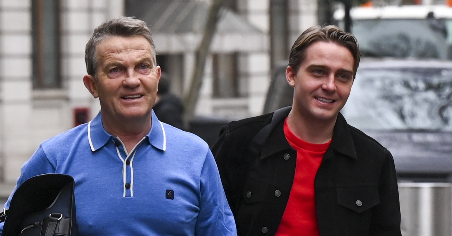 Smiling Bradley and Barney Walsh walking down the street together