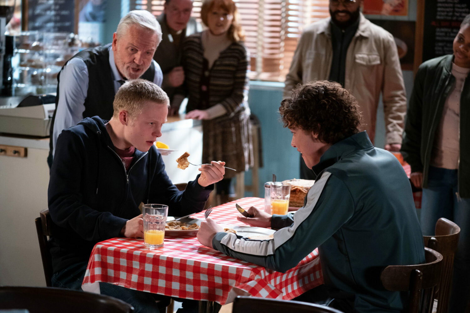 Rocky cheers while Bobby Beale and Freddie Slater eat pancakes