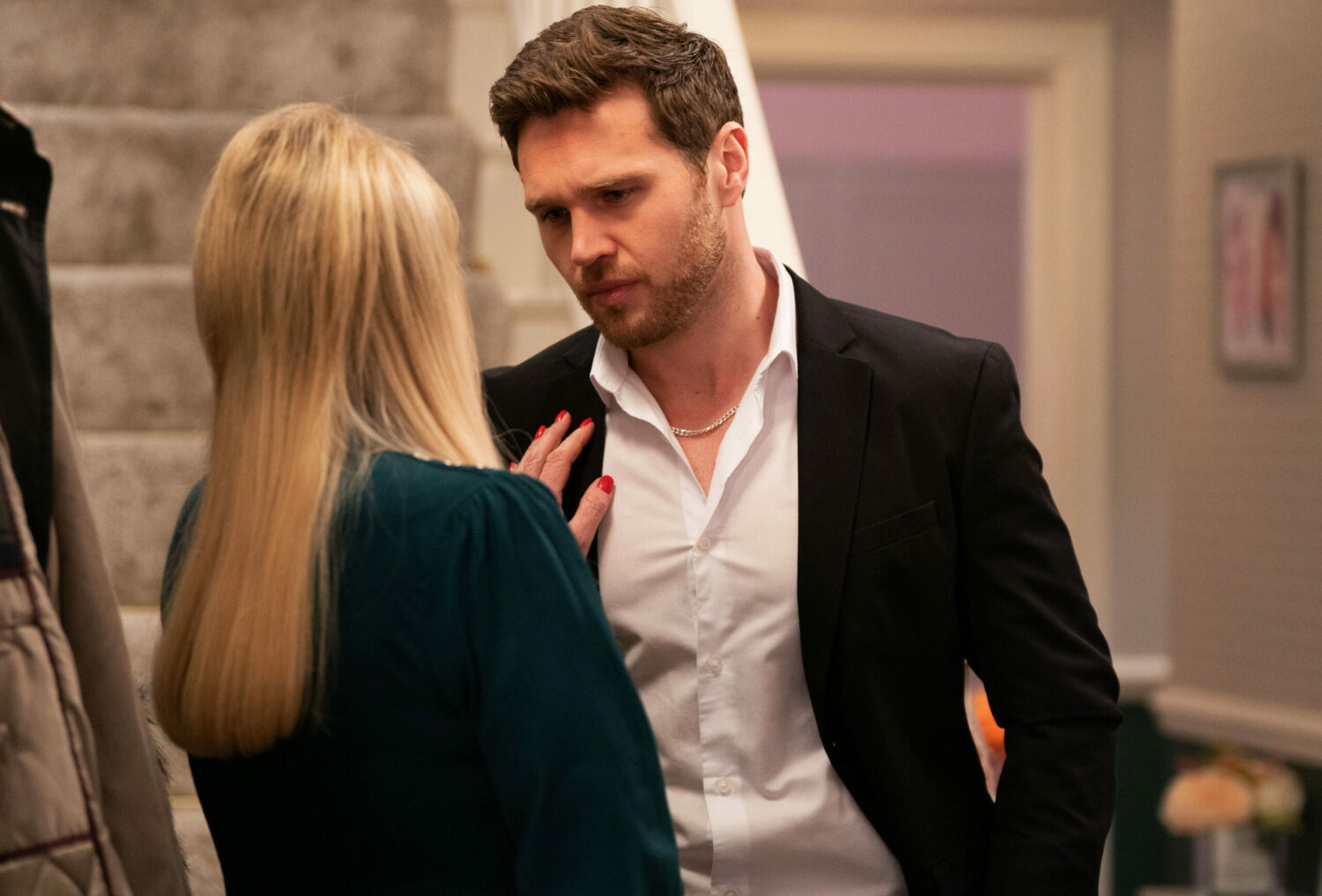 Sharon puts her hand on Keanu's chest as they talk on EastEnders