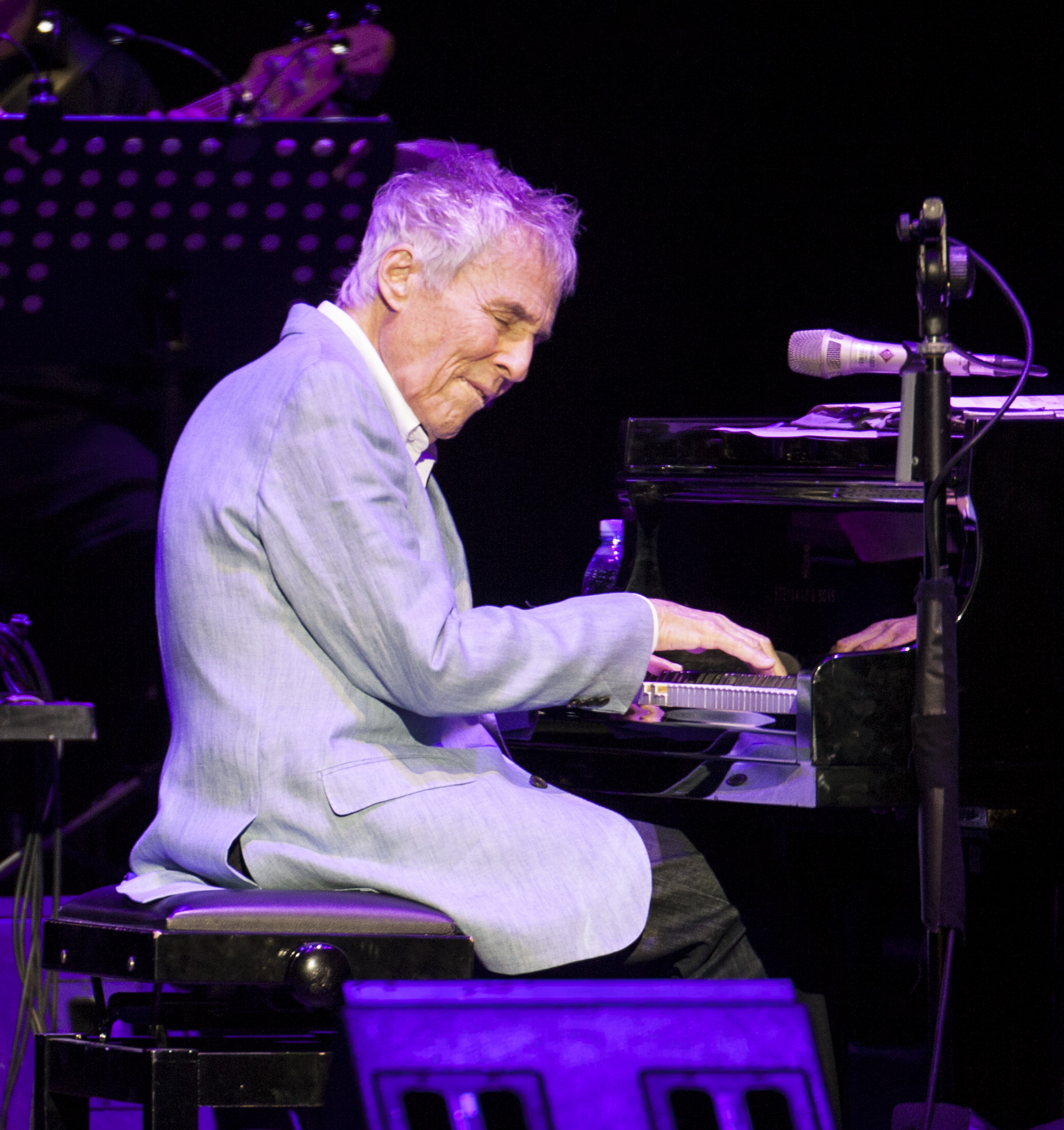 Burt Bacharach playing the piano on stage