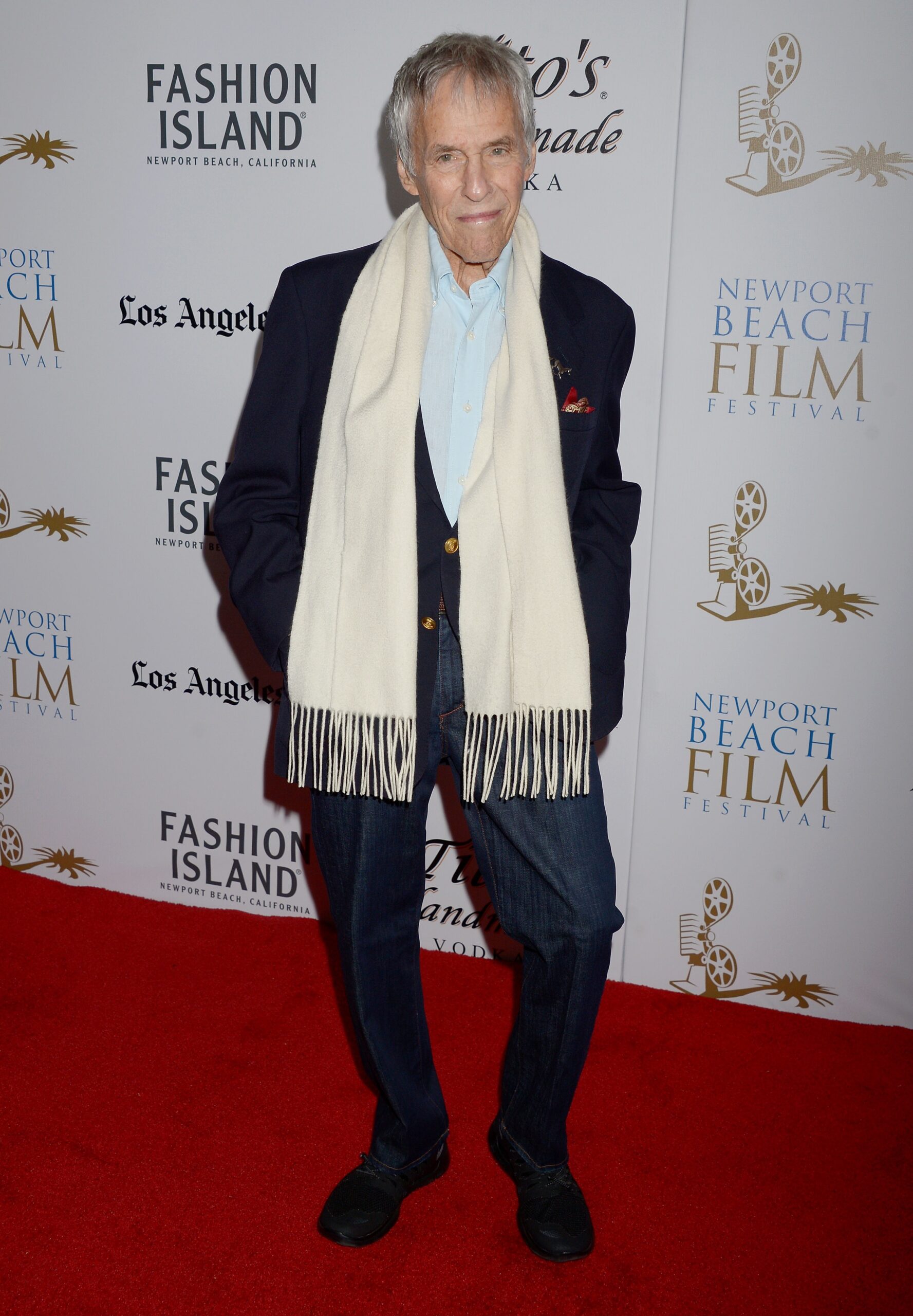 Burt Bacharach smiling on the red carpet wearing a scarf