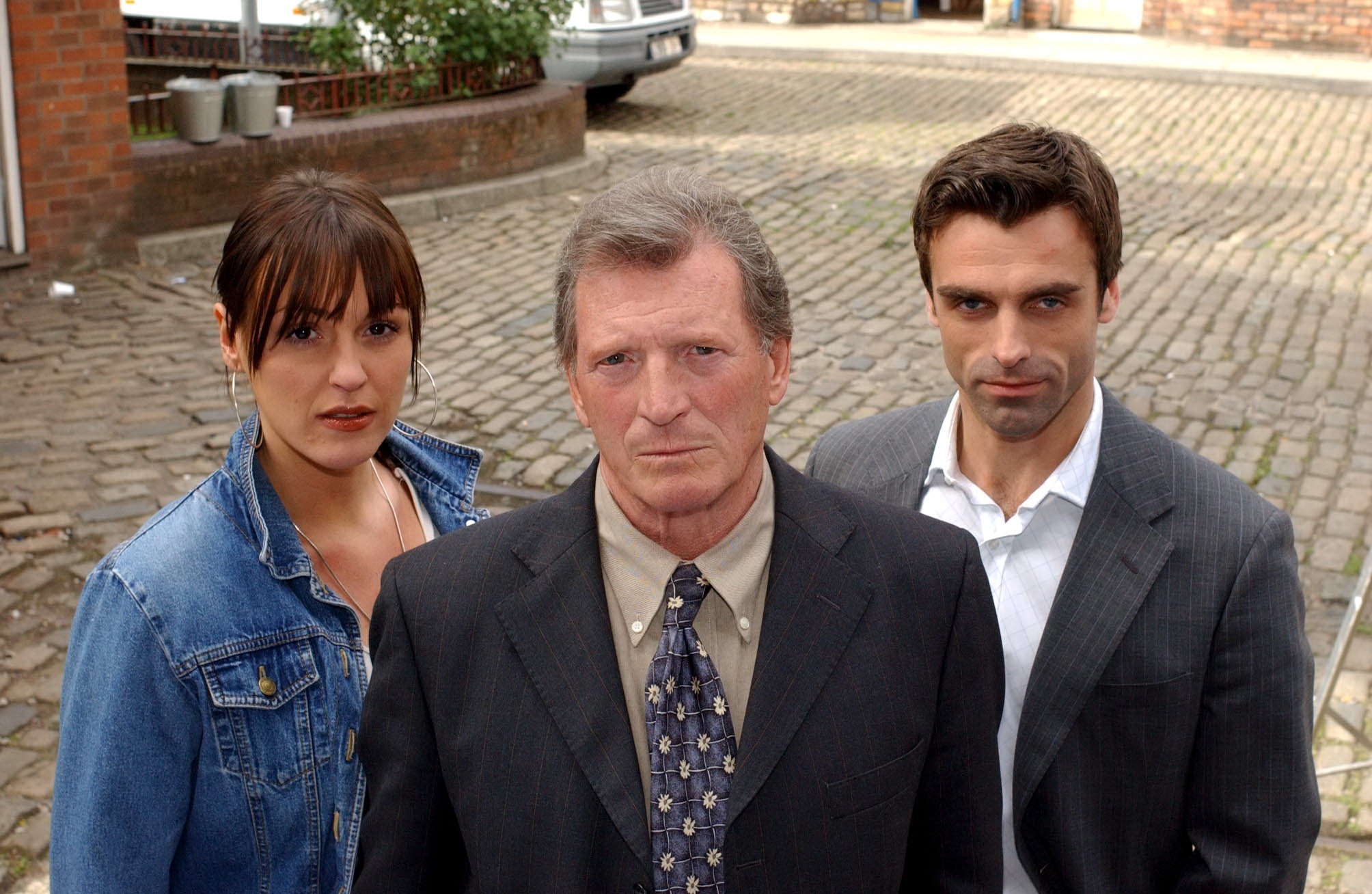 Mike Baldwin stands in between Karen McDonald and Joe Carter on the cobbles