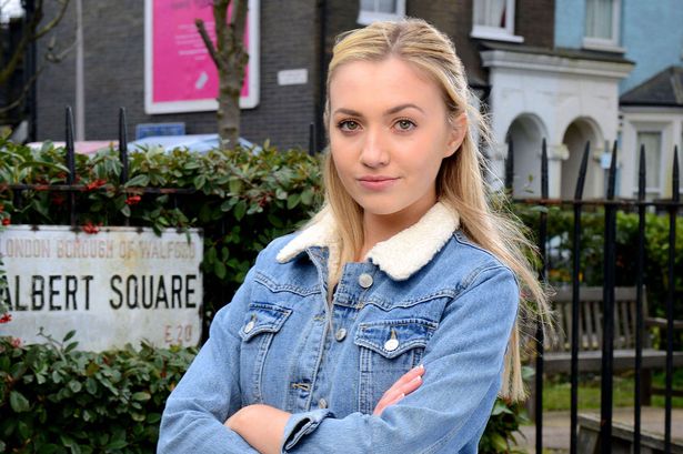 Louise Mitchell folds her arms in EastEnders