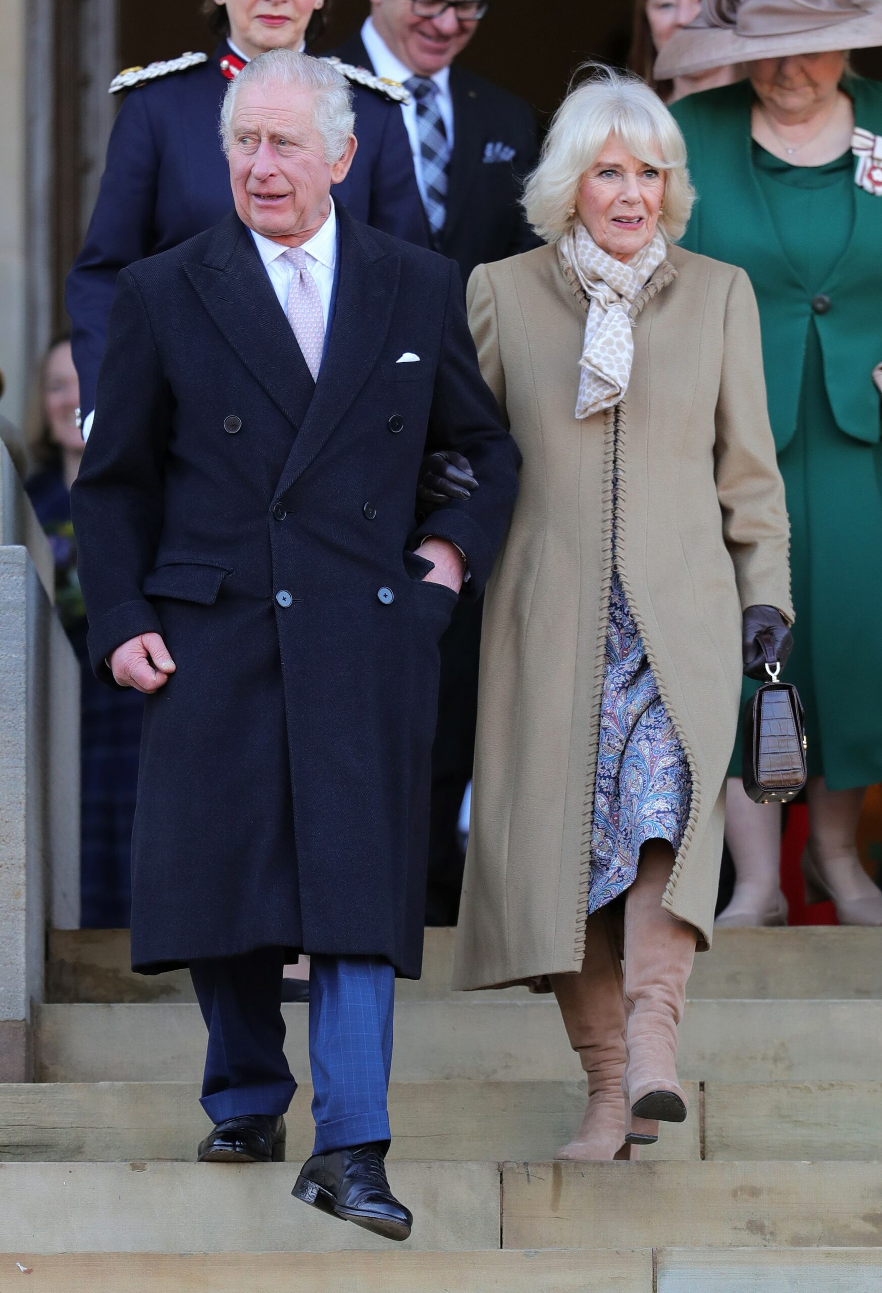 King Charles and Camilla smiling during royal engagement