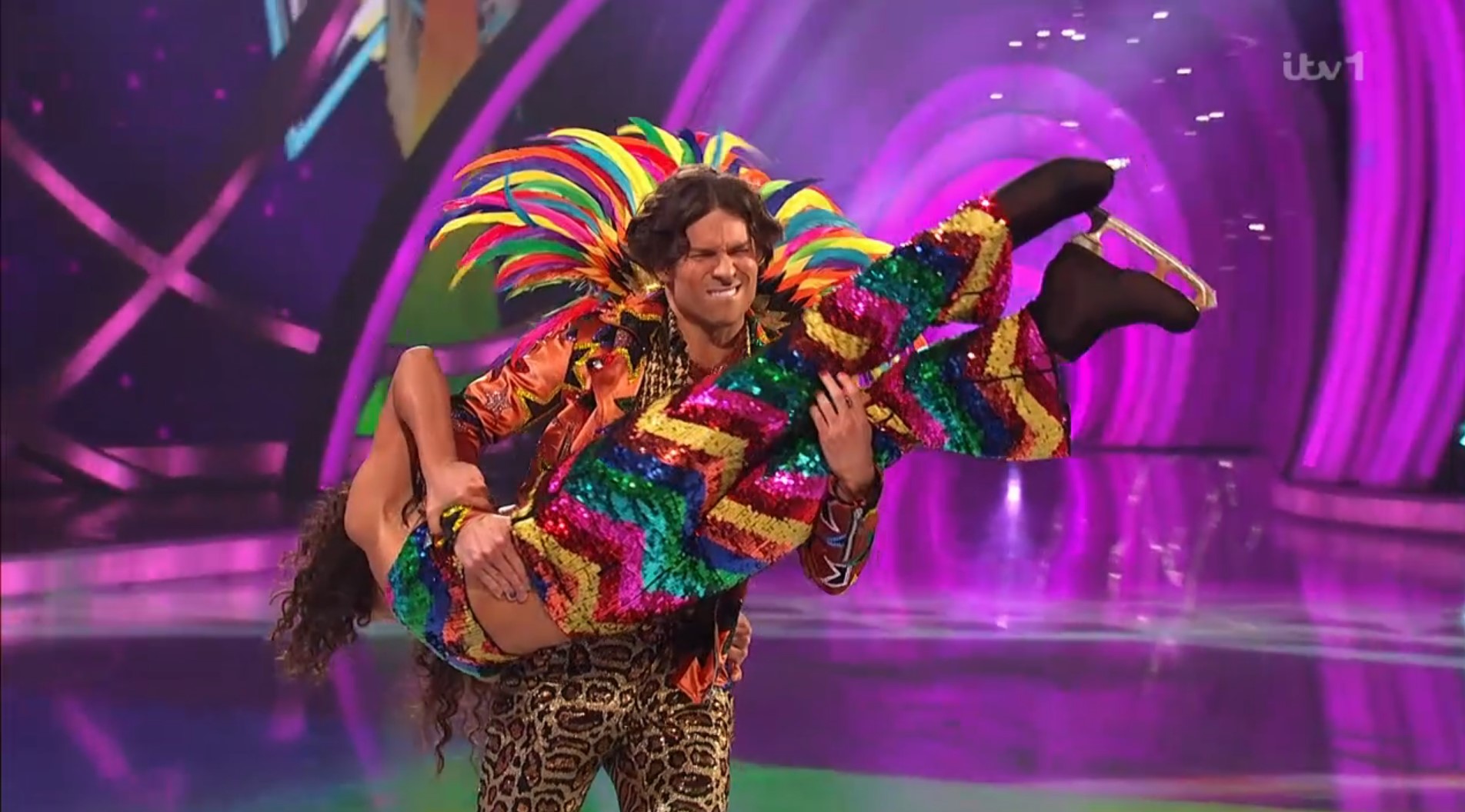 Joey Essex lifts Vanessa Bauer on the ice in very colourful clothing