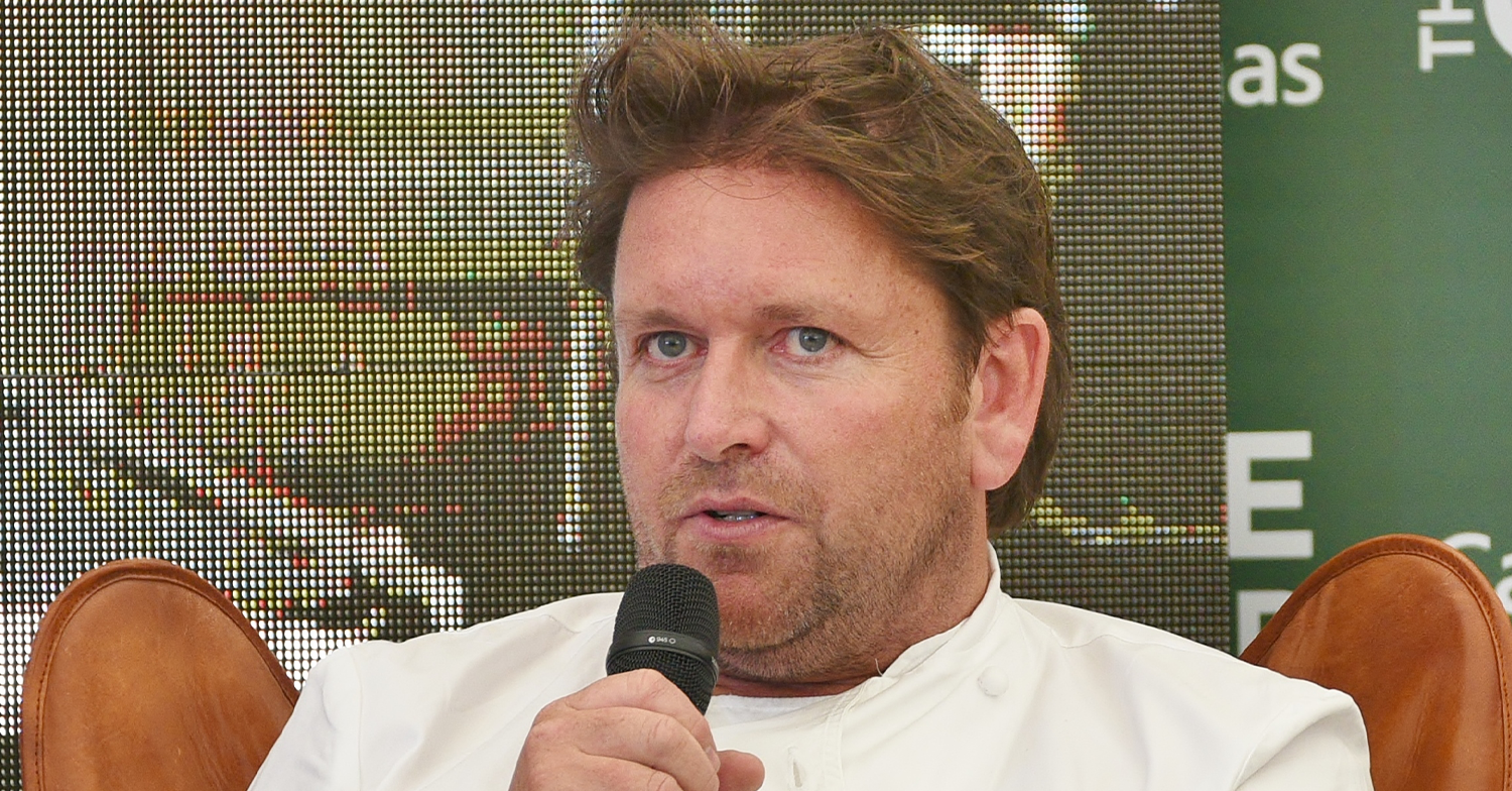 James Martin speaking into a mic on stage