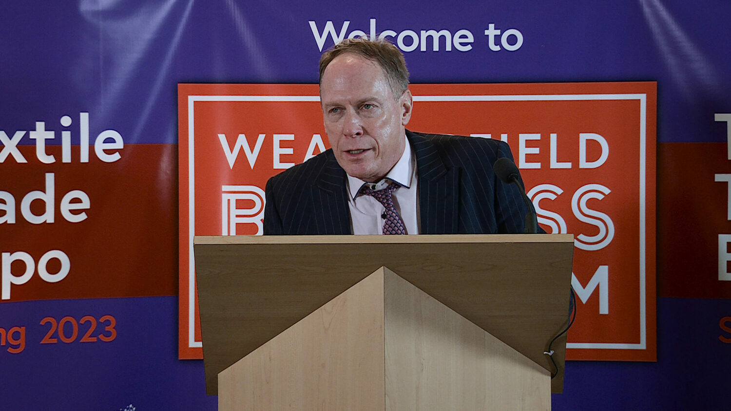 Stephen on a stage, making a presentation on Coronation Street