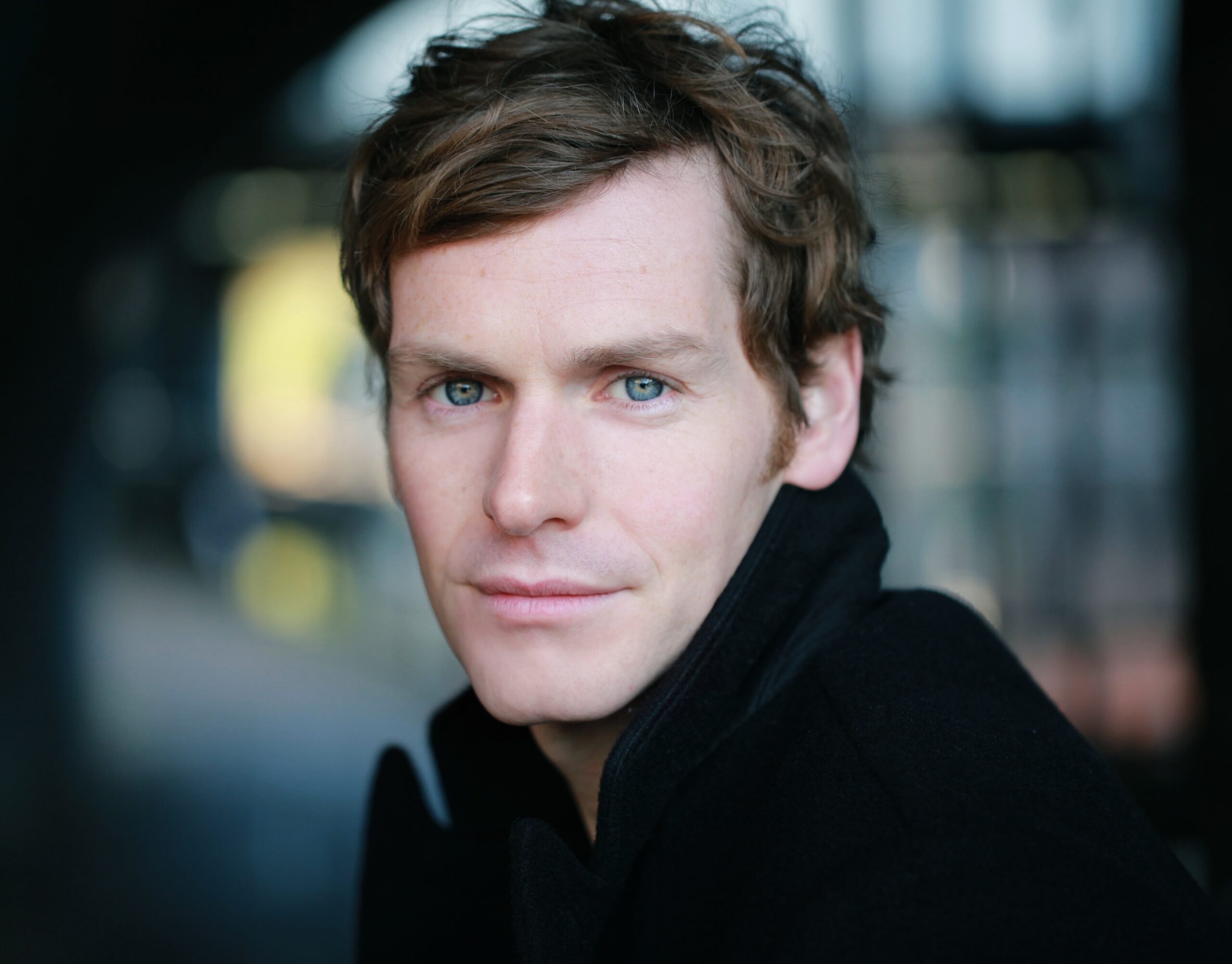 Shaun Evans smiles in head shot