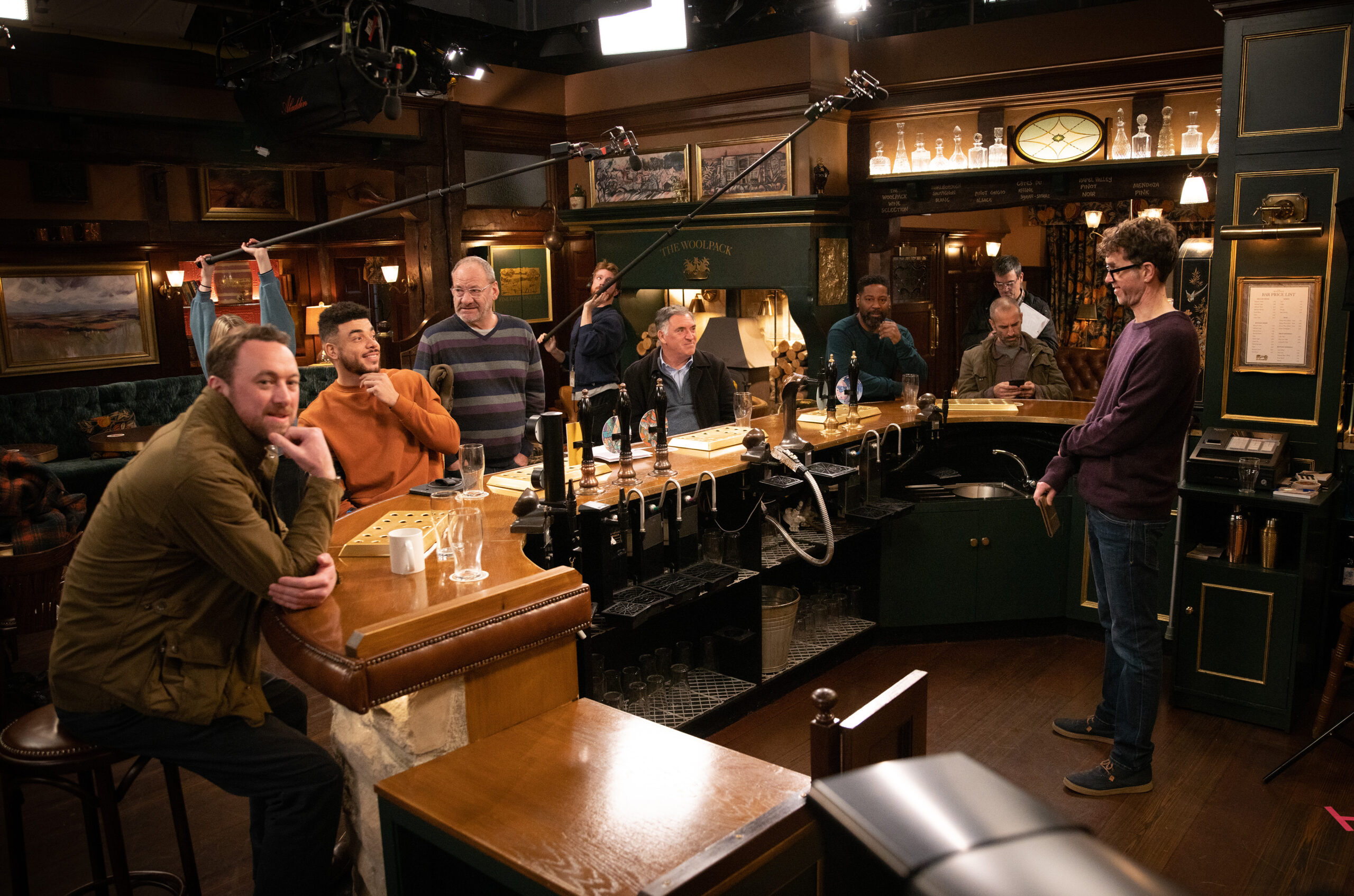Emmerdale's male cast members are gathered around the bar in The Woolpack