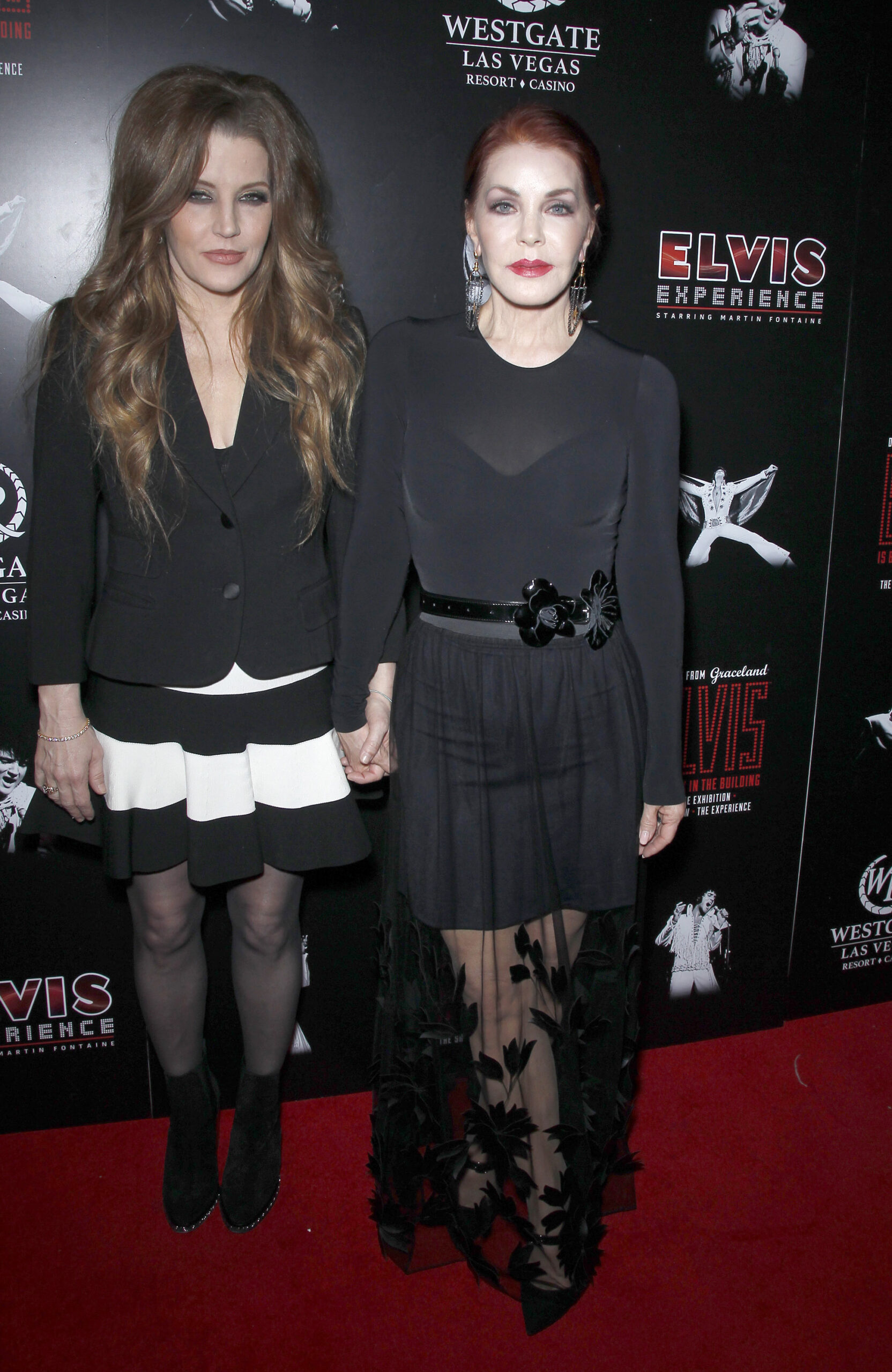 Lisa Marie and Priscilla Presley holding hands on the red carpet