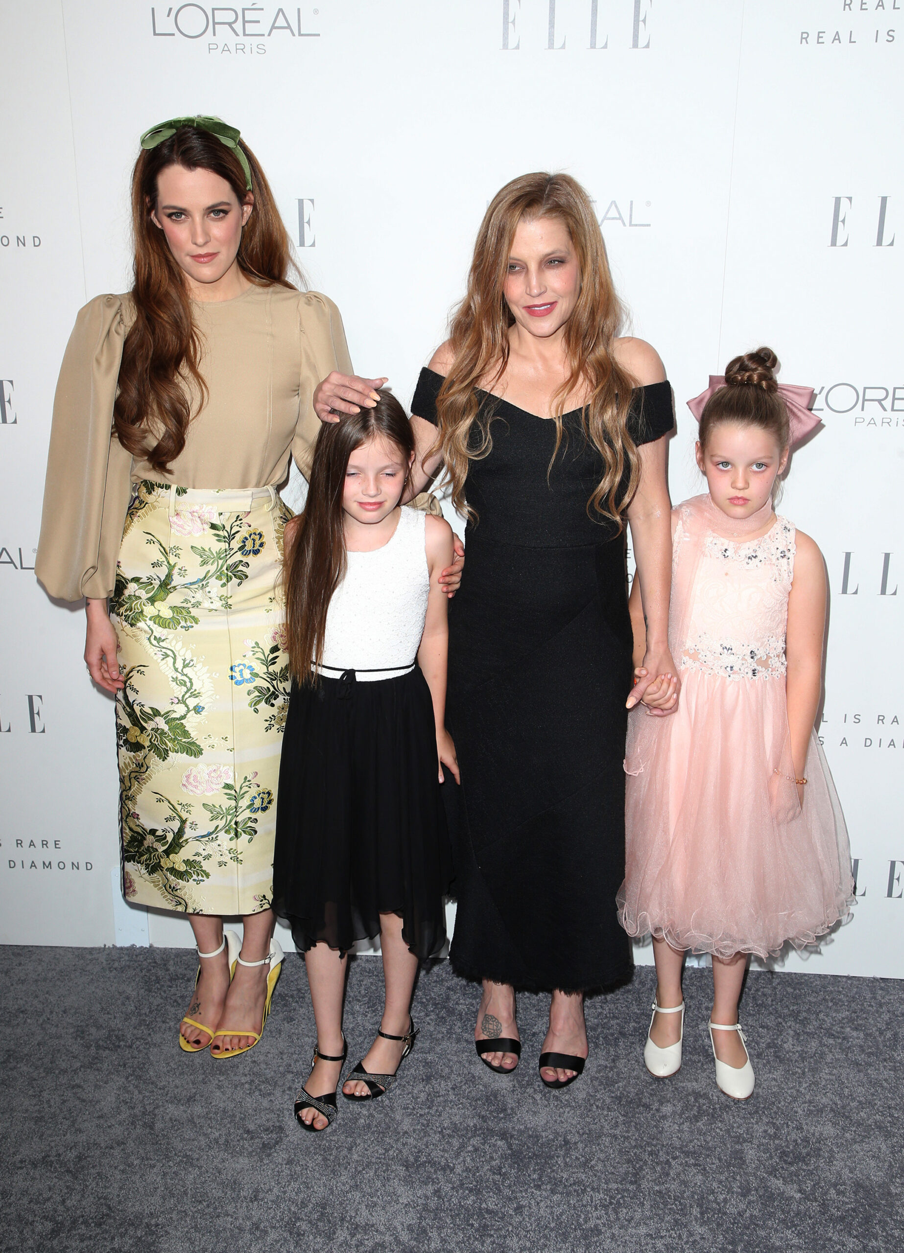 Lisa Marie Presley smiling with her three daughters
