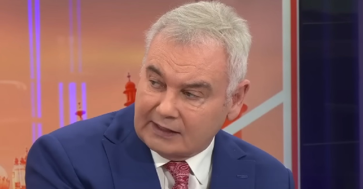 Eamonn Holmes in blue suit while speaking on GB News