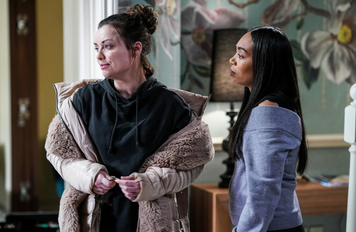 Whitney looks away as Chelsea talks to her on EastEnders