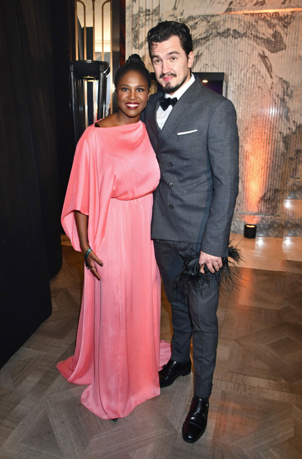 Motsi Mabuse and husband Evgenij Voznyuk pose together. She's wearing a pink dress.