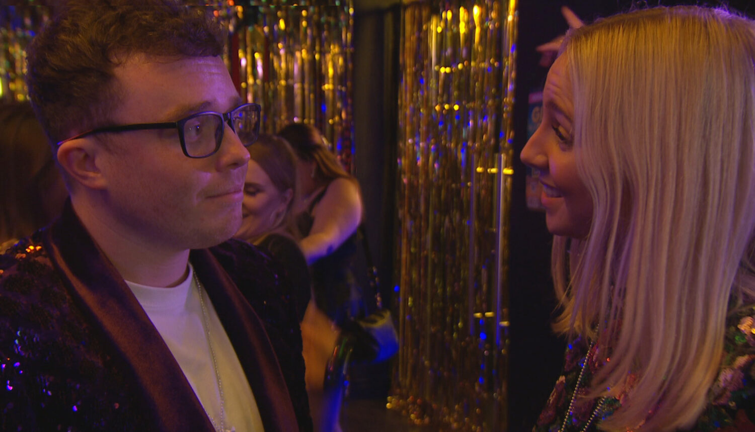 Vinny and Belle laughing in a club on Emmerdale