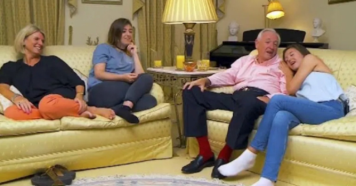 The Delaney-Ellwood family sitting on their sofa