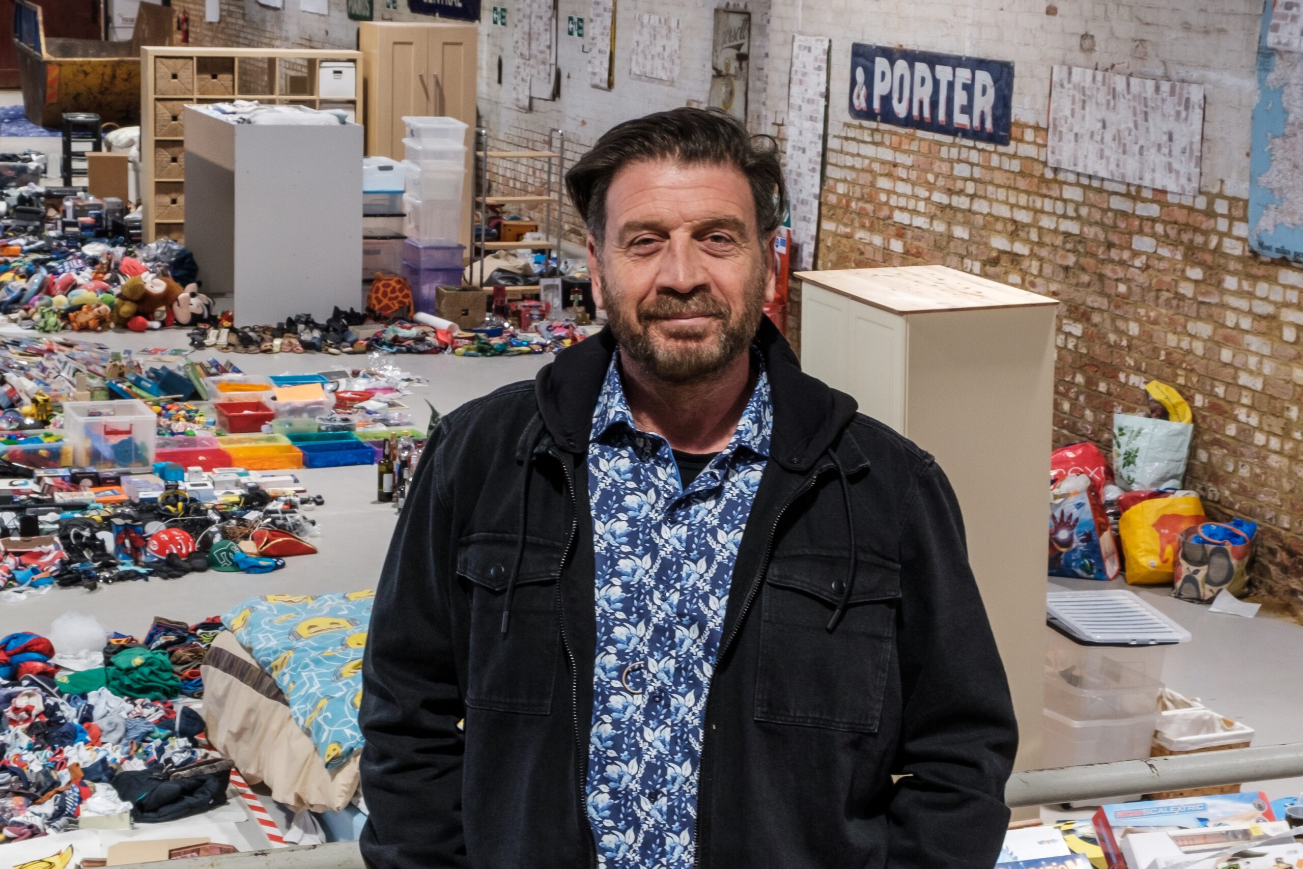 Nick Knowles standing in front of clutter in Big House Clearout