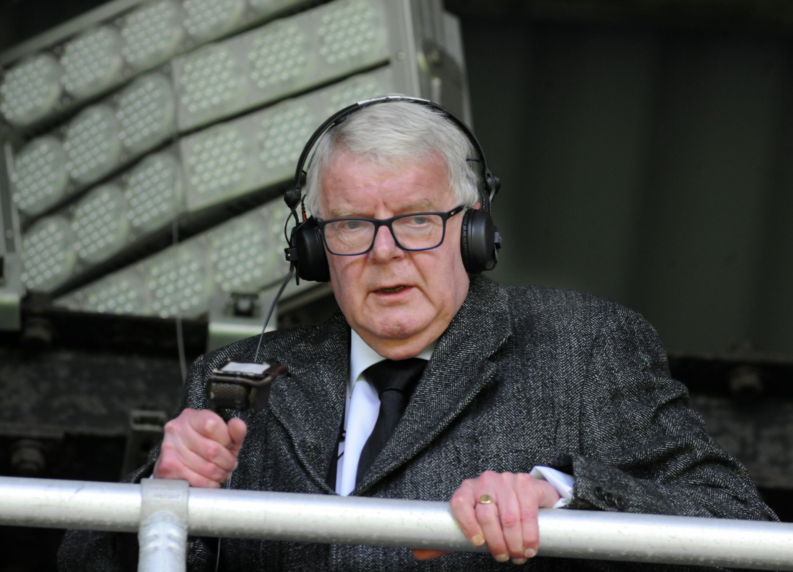 John Motson commentating with a microphone