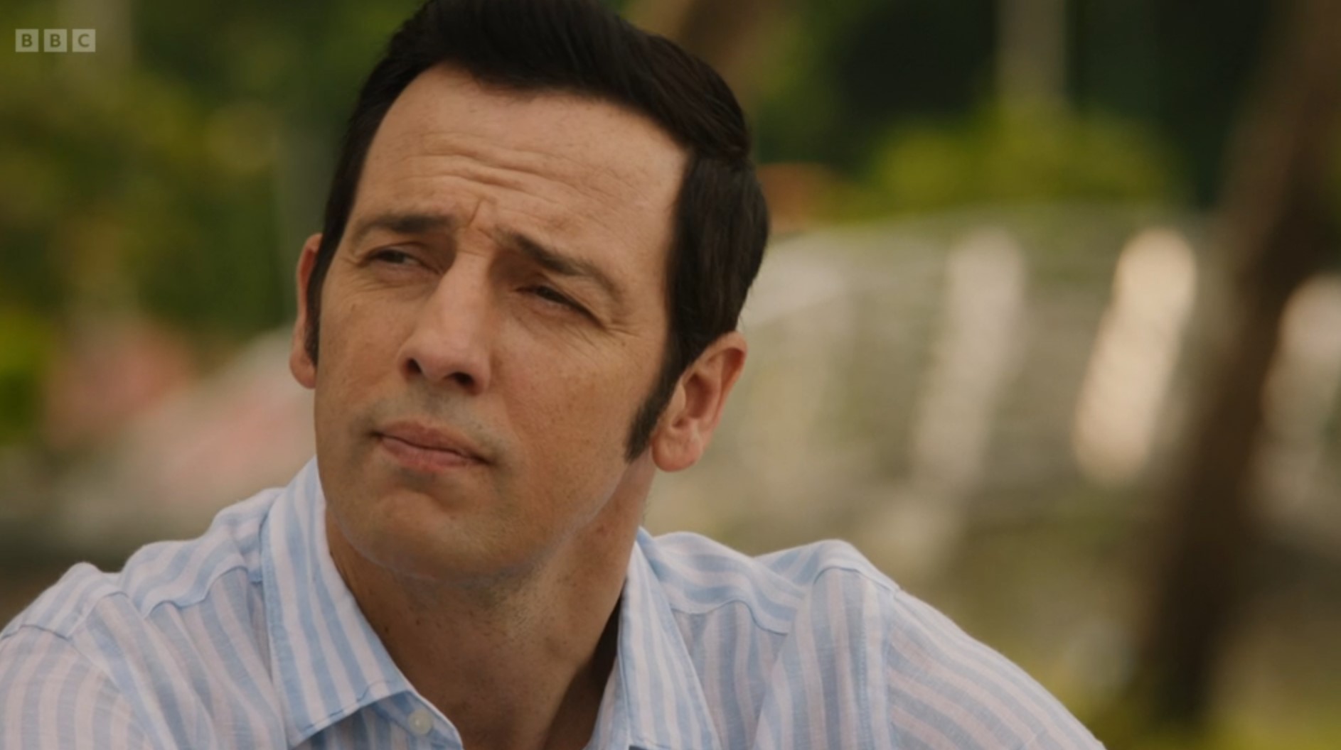 Neville Parker looks wistful as he sits on the beach