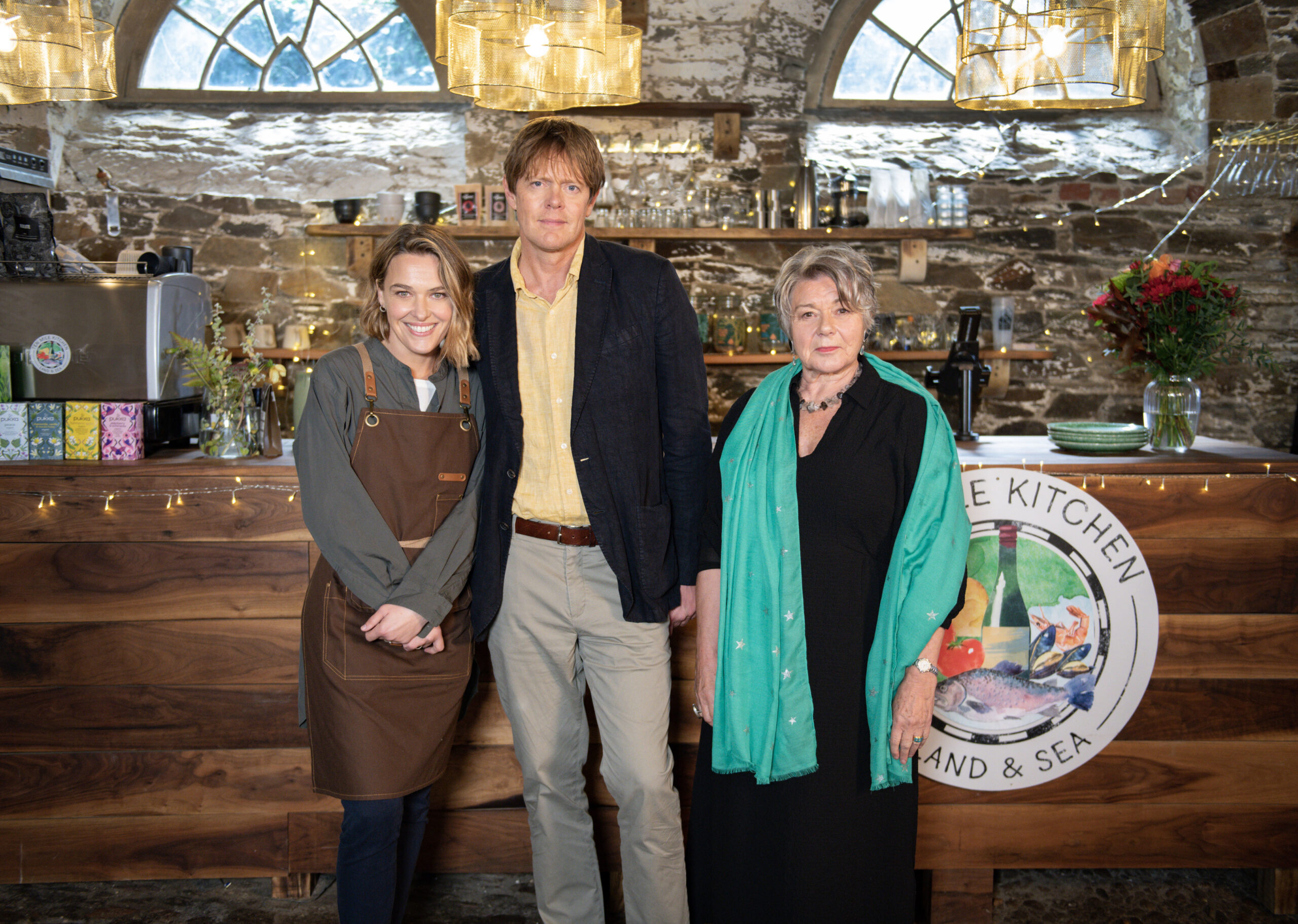 Martha, Humphrey and Anne post in the restaurant 