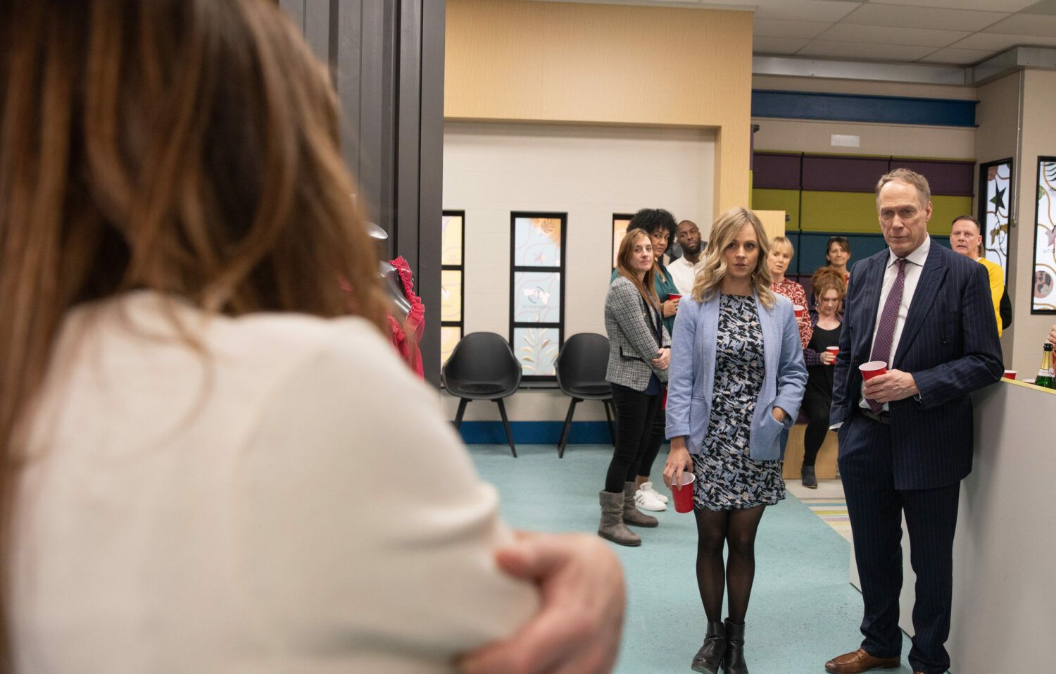 Sarah and Stephen are staring at Carla in the factory
