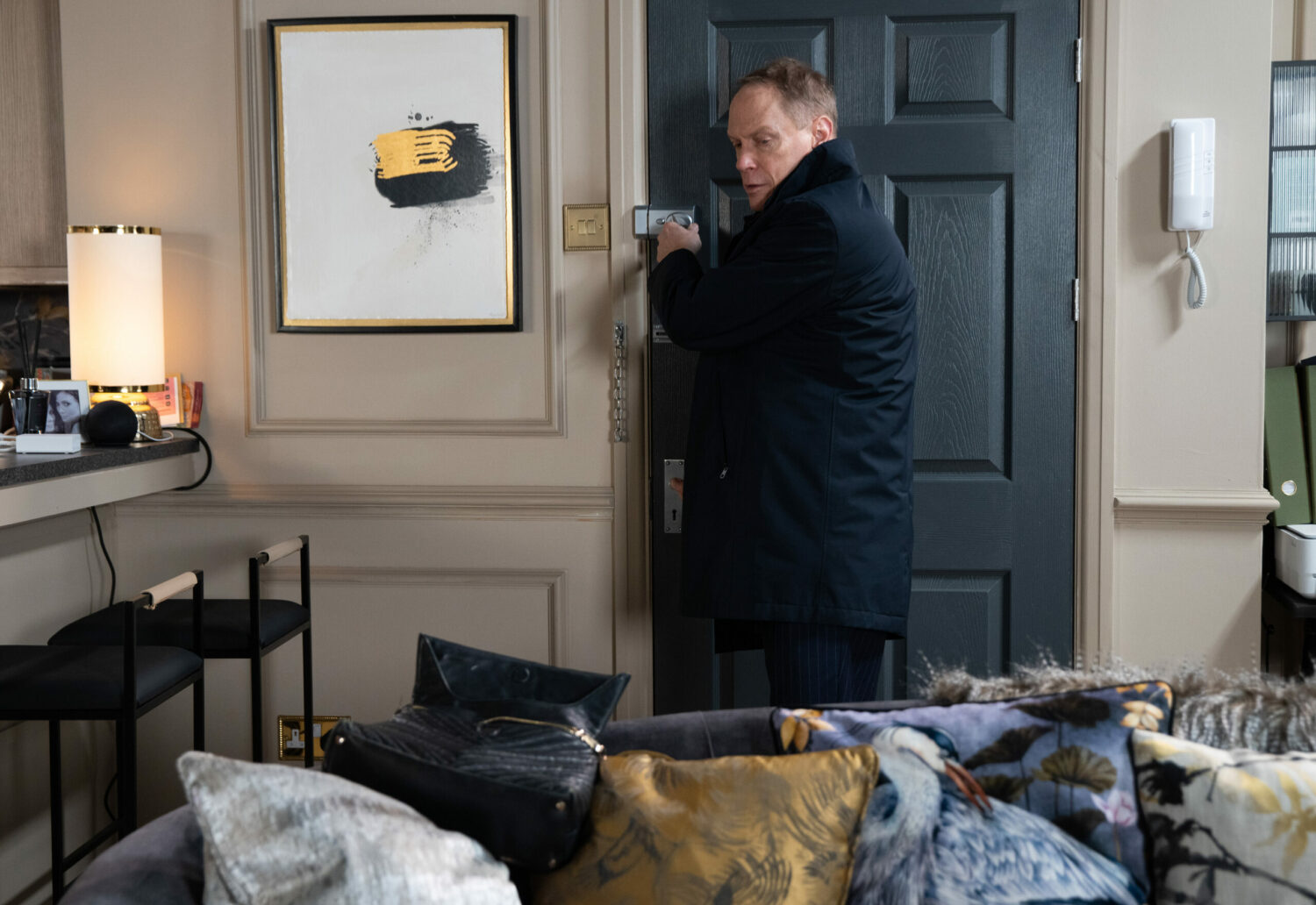 Stephen is standing at the door of Peter and Carla's flat