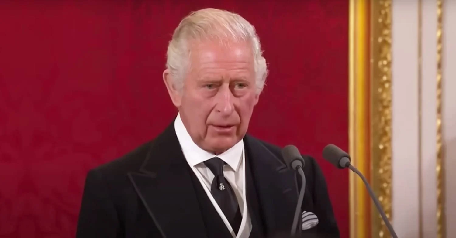 King Charles speaking into a microphone 